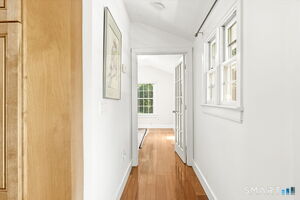 Hall leading to primary suite from kitchen.