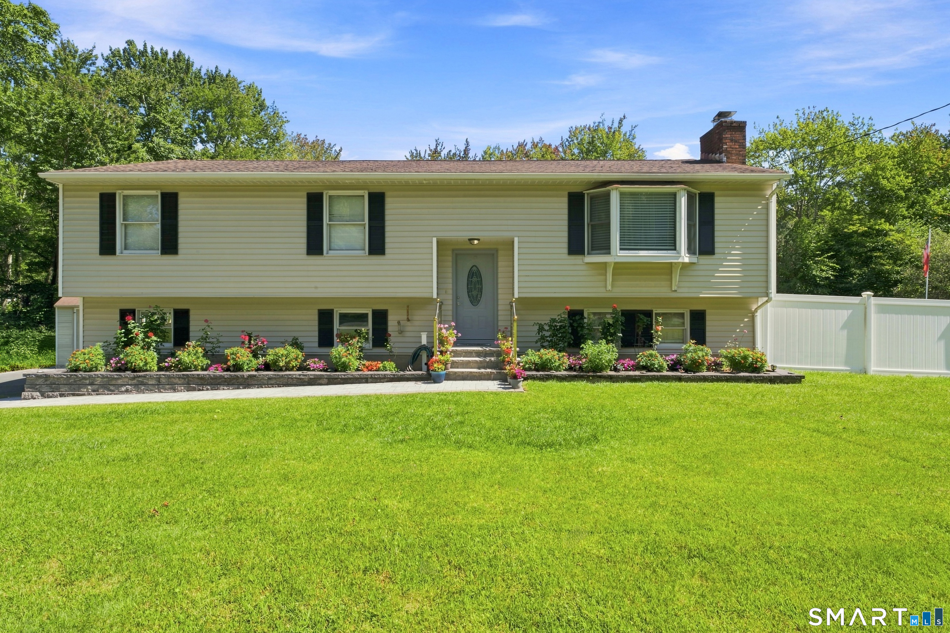 Welcome to 5 Sherwood Drive, a well-maintained and cared for house, professionally landscaped, beautiful curb appeal, located on flat lot on a quiet street close to everything, with quick access to I-84. Upon entering you will notice a paved walkway and nice steps and beautiful flowers along the way to the main entrance. Main level you will find living room with a fireplace covered with stone facing all way up to the high ceilings, followed by dining room with skylight. Kitchen is being updated with granite countertops, backsplash tiles, new hardware and Stanley steel appliances. Primary bedroom with its own full bath, 2 bedrooms and another full bath with tub completing this level, which has beautiful hardwood floors throughout. The lower level is tiled throughout and has a nice family room with a fireplace and inserted woodstove; part of this living area is used as an additional guest bedroom. Another bathroom with stand-up shower is located next to the utilities room