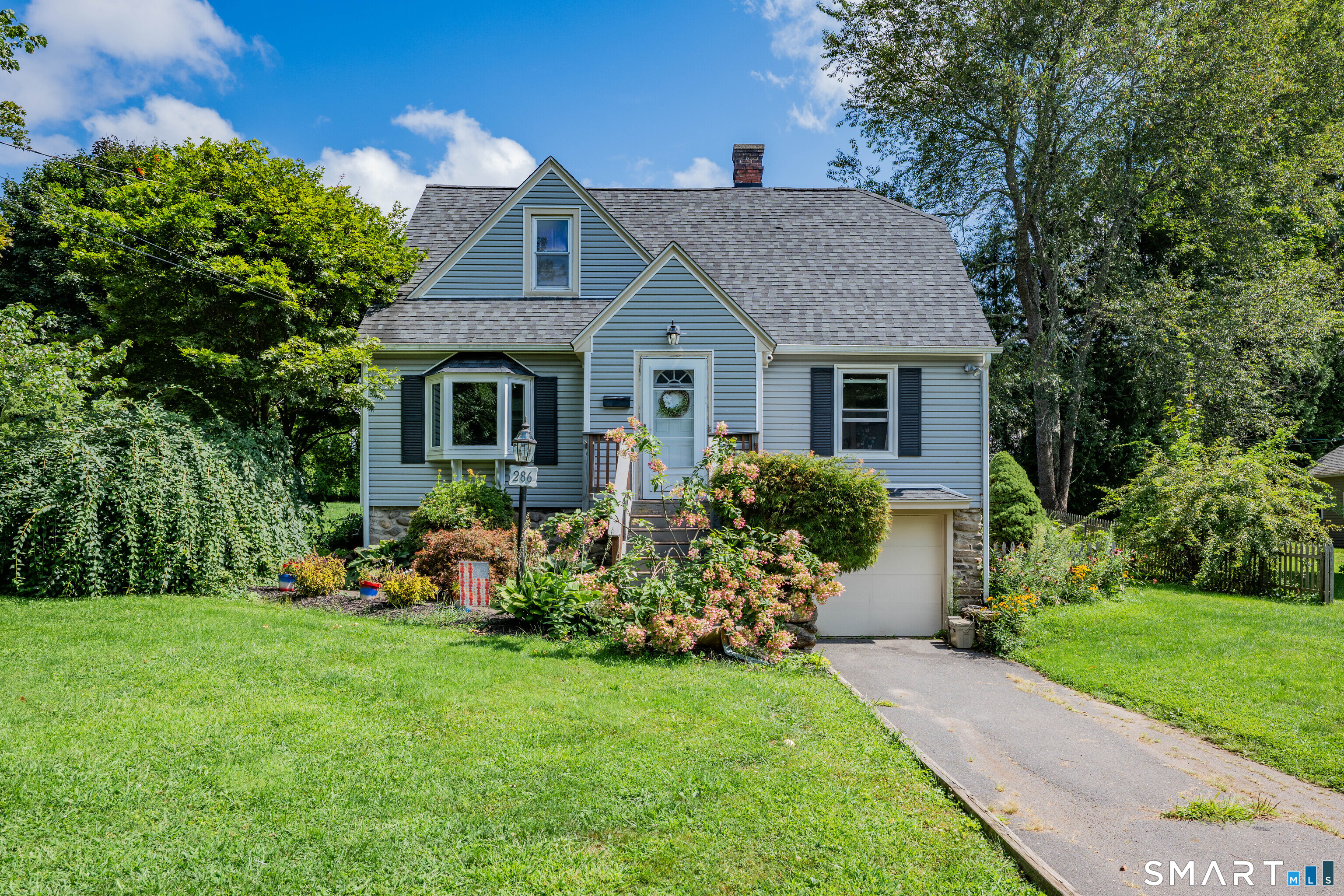 Cute as a button, this expanded Cape is conveniently located near Taft School and within walking distance to downtown Watertown. Hardwood floors run throughout much of the home, where the first floor offers a spacious living room with a pellet stove, dining room, kitchen, and full bath. Just off the kitchen, the sunken family room is a welcome addition, featuring a propane fireplace flanked by built-ins and access to the back deck. Upstairs, the primary suite offers an updated bathroom and generous closet space, along with two additional bedrooms, including one with built-ins. Outside, enjoy the large back deck, a level yard with room to play, and a one-car under-house garage. A charming home in a convenient Watertown location!