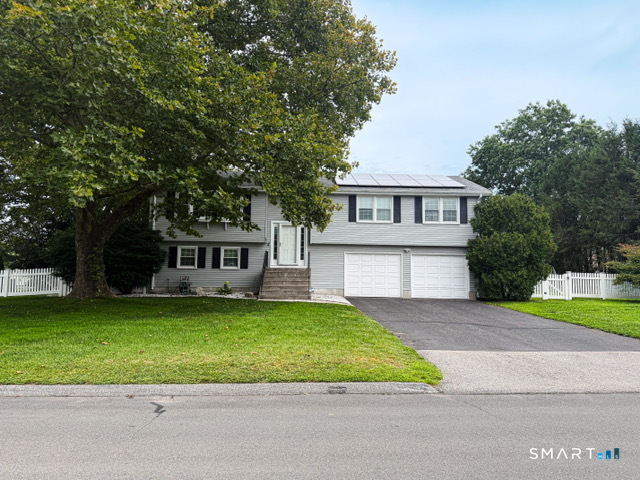 Welcome home to this beautifully updated raised ranch, set on a private corner lot in one of Cromwell's most established neighborhoods. Minutes from Route 9 and I-91 and close to shopping and dining, it offers both convenience and comfort. Inside, warm hardwood floors run through a sun filled main level anchored by a living room bay window. The kitchen flows seamlessly into a spacious dining room with a slider to the Trex deck, ideal for entertaining or quiet nights at home. The primary suite offers a walk in closet and remodeled bath, and two more generously sized bedrooms share an updated hall bath. The walk out lower level provides flexible space for a family room, home office, or guest suite, complete with a cozy fireplace and direct access to the patio. Outside, the level .36-acre lot offers privacy and room to gather, with an above ground pool and fire pit ready for summer. With natural gas heat, central air, and updated windows, this home is ready for you to move right in.