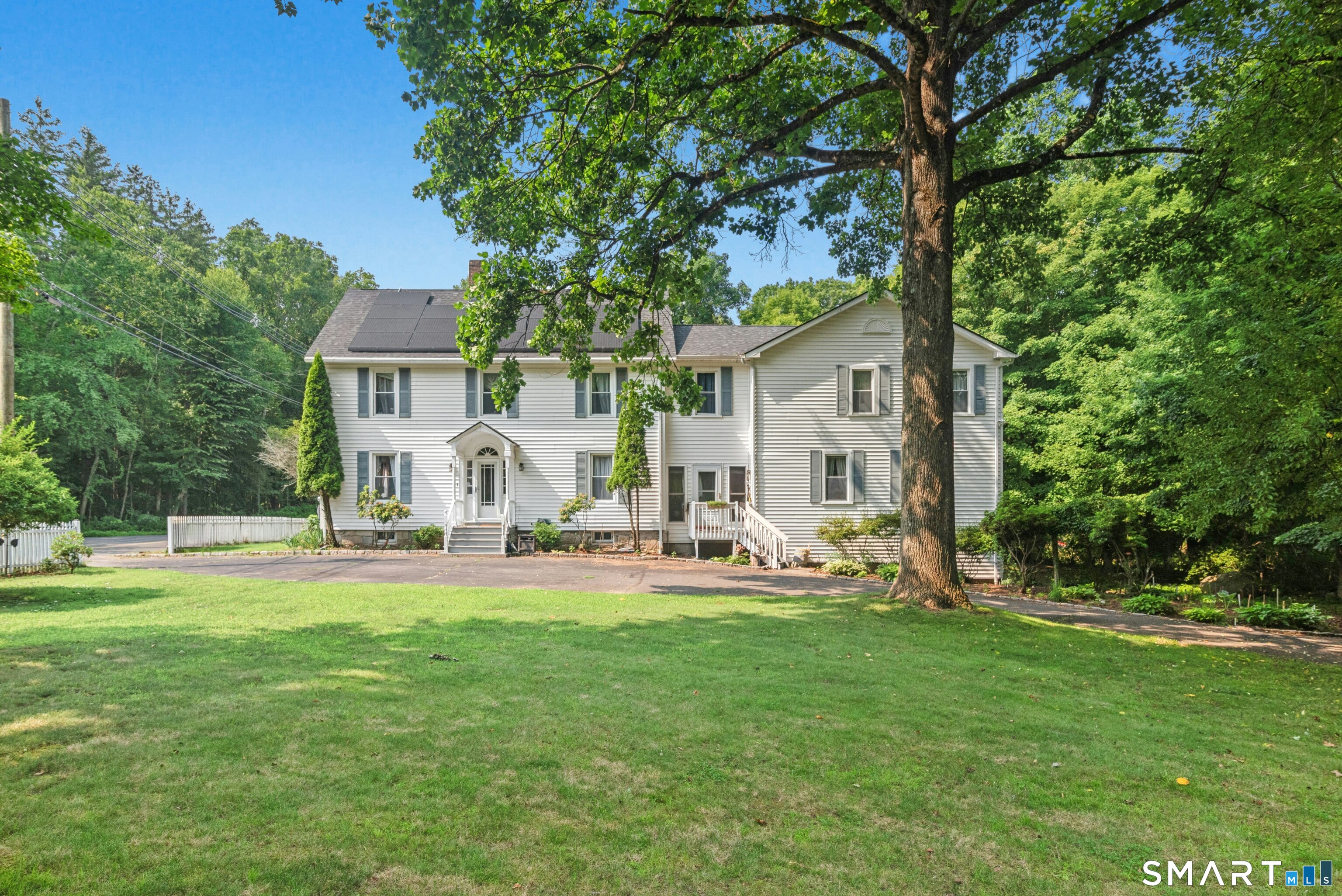 Exceptional space, flexibility and privacy await in this charming Colonial, set on 1.3 lightly wooded acres near the Woodbridge line. A true main-level in-law suite with a private entrance is the standout feature, offering its own kitchen, living and dining areas, bedroom, full bath, laundry and office-ideal for extended family, guests or multigenerational living. In the main home, the eat in kitchen features granite counters, stainless steel appliances, hardwood flooring, generous cabinetry and a sunny breakfast nook. The inviting living room offers a masonry fireplace, abundant natural light and access to the expansive rear deck. Upstairs are four bedrooms, including a spacious primary suite with a private balcony, peaceful views, dressing room, office, walk-in closet, laundry area and full bath with separate glass-enclosed shower. A finished walkup attic provides flexible space for an office, playroom, bedroom, hobbies or storage. Enjoy three decks, an awning and above-ground pool, creating the perfect setting for gatherings and enjoyment. Additional highlights include newer HVAC, unfinished dry lower level for storage, a circular driveway, ample parking and an attached two-car garage. Convenient to commuter routes, shopping, schools, parks, hiking and Seymour's historic district, this distinctive property offers room for everyone and possibilities for every stage of life. Contingent Upon Seller Finding Suitable Housing.