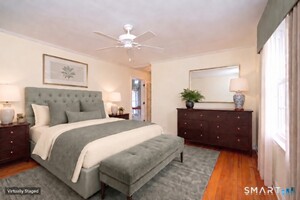 The primary bedroom is part of a spacious suite with a walk-in closet and beautifully redesigned bath.