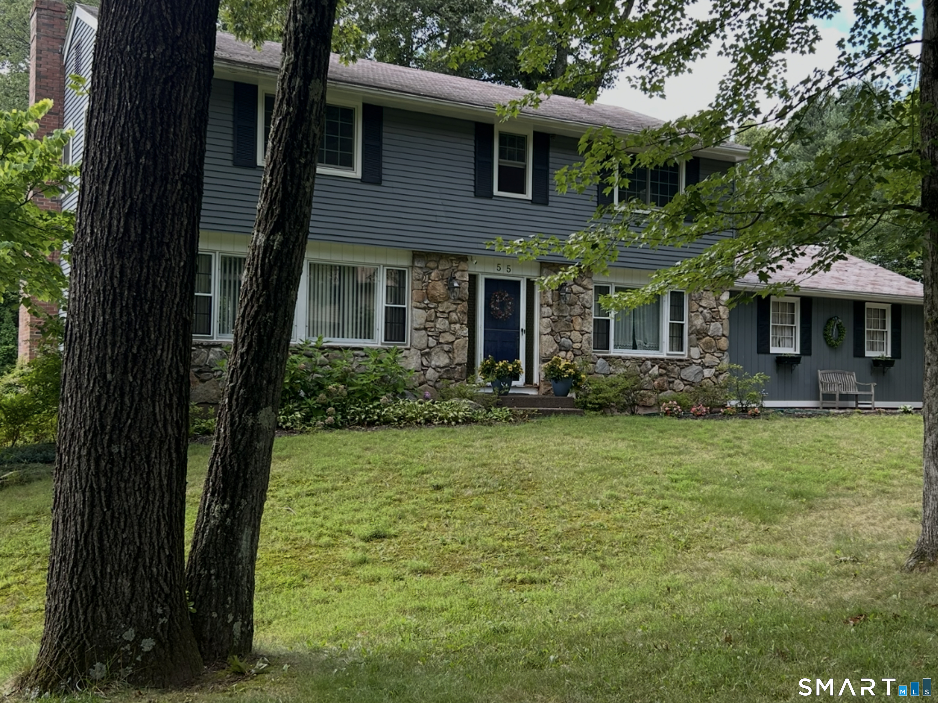 Beautiful 4br, 2 1/2 bath colonial with a stunning remodeled kitchen including travertine flooring, granite, recessed lighting, subway tile & breakfast bar overlooking new expansive trex deck & serene evergreens that invite hospitality. This home features refinished hardwood floors, new windows, updated baths including dual sink vanity with marble and also smart home integration, thermostat control & indoor ceiling speakers. Located in a slightly wooded neighborhood just minutes from amenities including recreational & medical facilities, public transportation, shopping & major interstates. Partially finished walk-out lower level provides additional 800 sq ft of recreational, craft or study space. This house is EV charger ready!