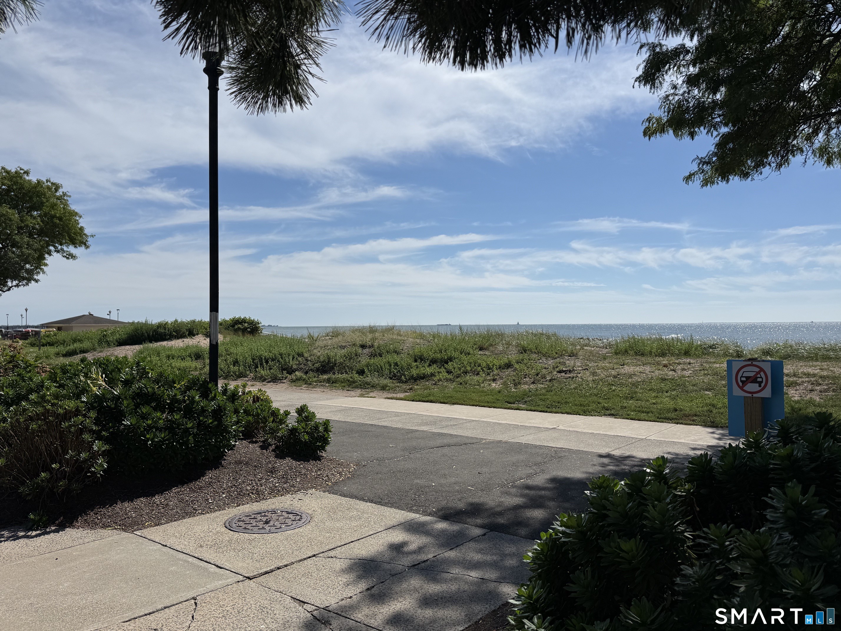 Wonderful Ranch unit with ocean views from the balcony!!!! One bedroom condo on 3rd level at West Walk in Savin Rock. Lovely hardwood floors, beautifully maintained white woodwork and ample windows with views of Long Island Sound. Open-floor plan draws you into the living room with a cozy electric fireplace and build-ins. Ample space for a small dining table. Open to nice flowing galley kitchen. Beautiful well-planned cabinetry is filled with space-saving extras. Lost of storage in the hallway including a closet with stack unit washer & dryer. The bedroom features high windows for added wall space for furniture layout. Double closet with organizers. Balconies outside both front and rear doorways provide extra access to outdoor spaces right out the door. Walk the boardwalk and enjoy the private fenced-in private pool, kayak rack for storage.