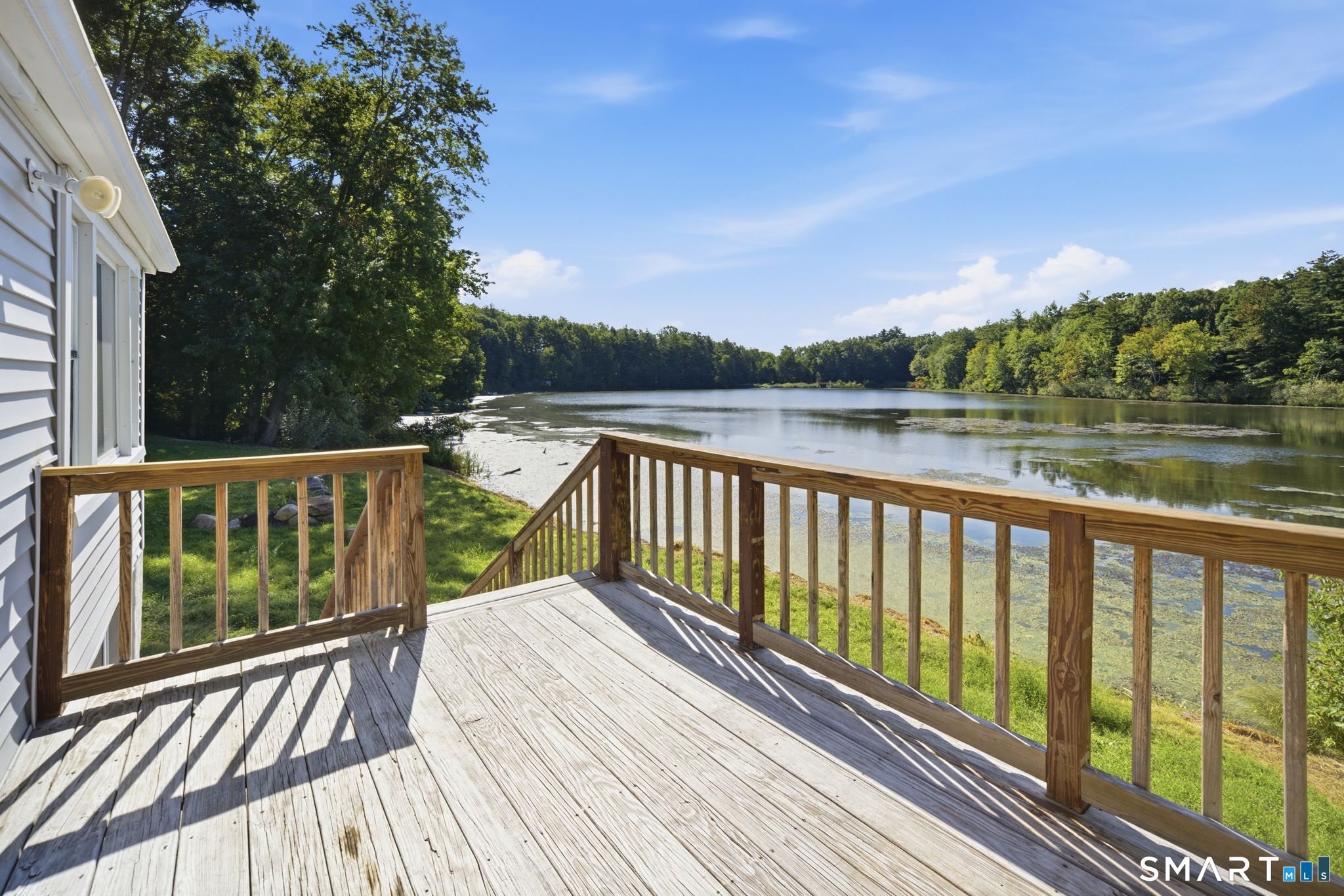 Lakefront living at its best! Set directly on the shores of Lake Basile, this charming waterfront bungalow offers an exceptional opportunity to enjoy beautiful water views and a truly special setting. Inside, a thoughtful interior makeover creates a warm and inviting atmosphere, highlighted by an oversized stone fireplace, vaulted ceilings, and a loft area that adds character and flexible space. The main living area captures the beauty of the lake, while the bedroom also offers water views to enjoy throughout the seasons. Step outside onto the large deck and take in the ever-changing scenery from your own waterfront retreat. The property also features a pleasant side yard with room for gardening, outdoor gatherings, or simply relaxing beside the lake.  The full walk-out basement provides valuable storage and expansion possibilities, while the enclosed lower porch area offers potential for additional finished space. Central air conditioning and a propane heating system add year-round comfort. Whether you're enjoying morning coffee overlooking the water, gathering on the deck, or simply taking in the peaceful lake setting, 39 Hemlock Road offers a rare opportunity to own direct waterfront property on Lake Basile. Conveniently located near shopping, trails, restaurants, and other amenities, yet with a setting that feels wonderfully removed from the everyday. A unique waterfront property with character, views, and lots of potential. Book your appointment today!