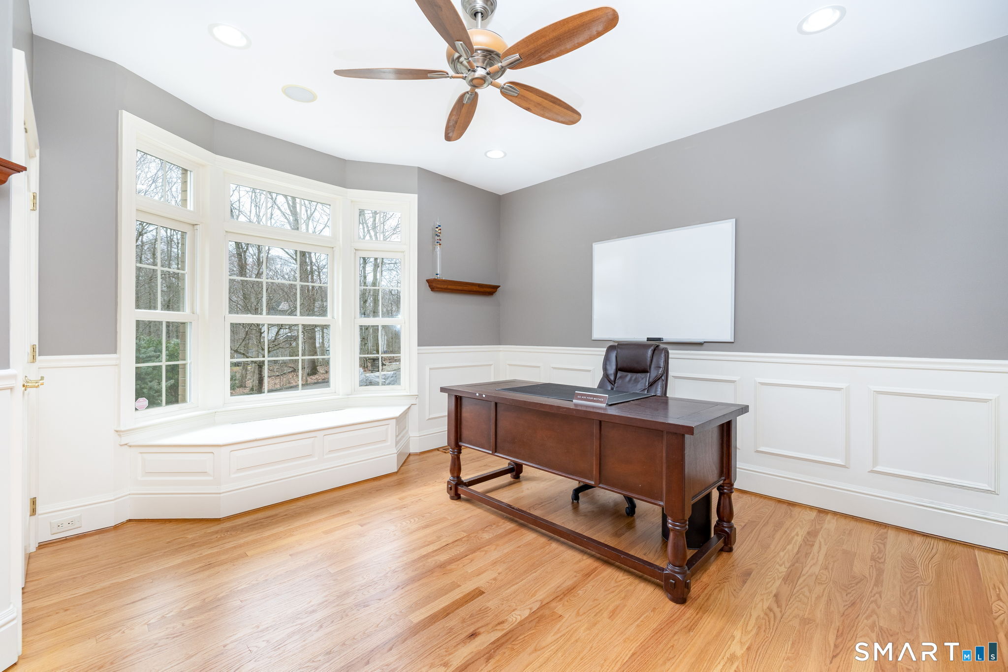This 14'2"x13'10" room overlooking the front of the house is currently used as a dedicated office, with gleaming refinished oak floors, French doors, closet, panel wainscotting, ceiling fan, bay window with transom windows & window seat with storage.