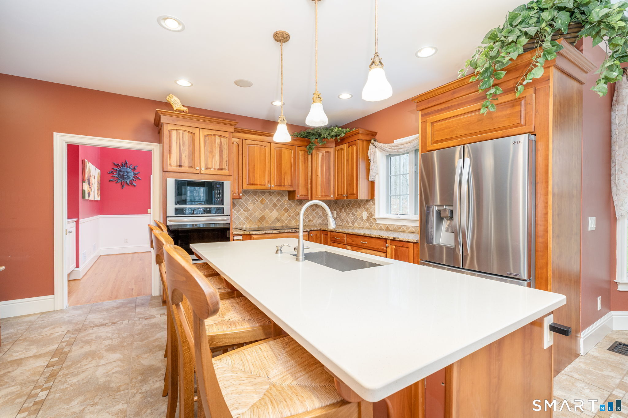 Cherry cabinets, granite counters, a quartz-covered island seating 4, stainless steel appliances, wall oven, a huge pantry, kitchen office space, and an eat-in space overlooking the backyard make this 23'3" x 13'3" kitchen shine!