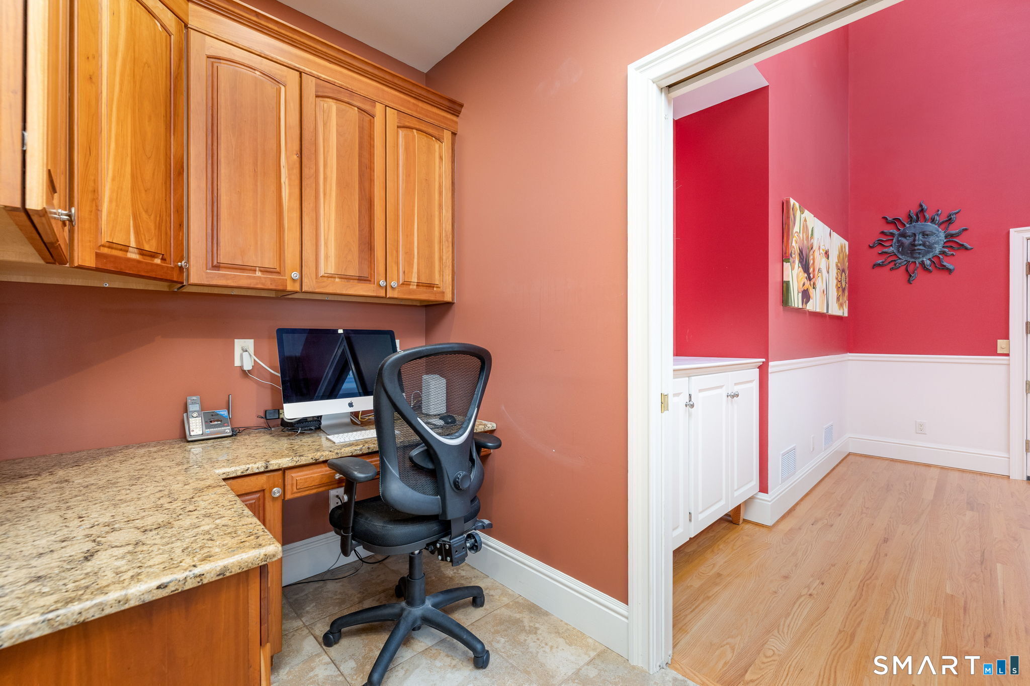 The kitchen also has a dedicated office space with more cherry cabinets and granite counters.