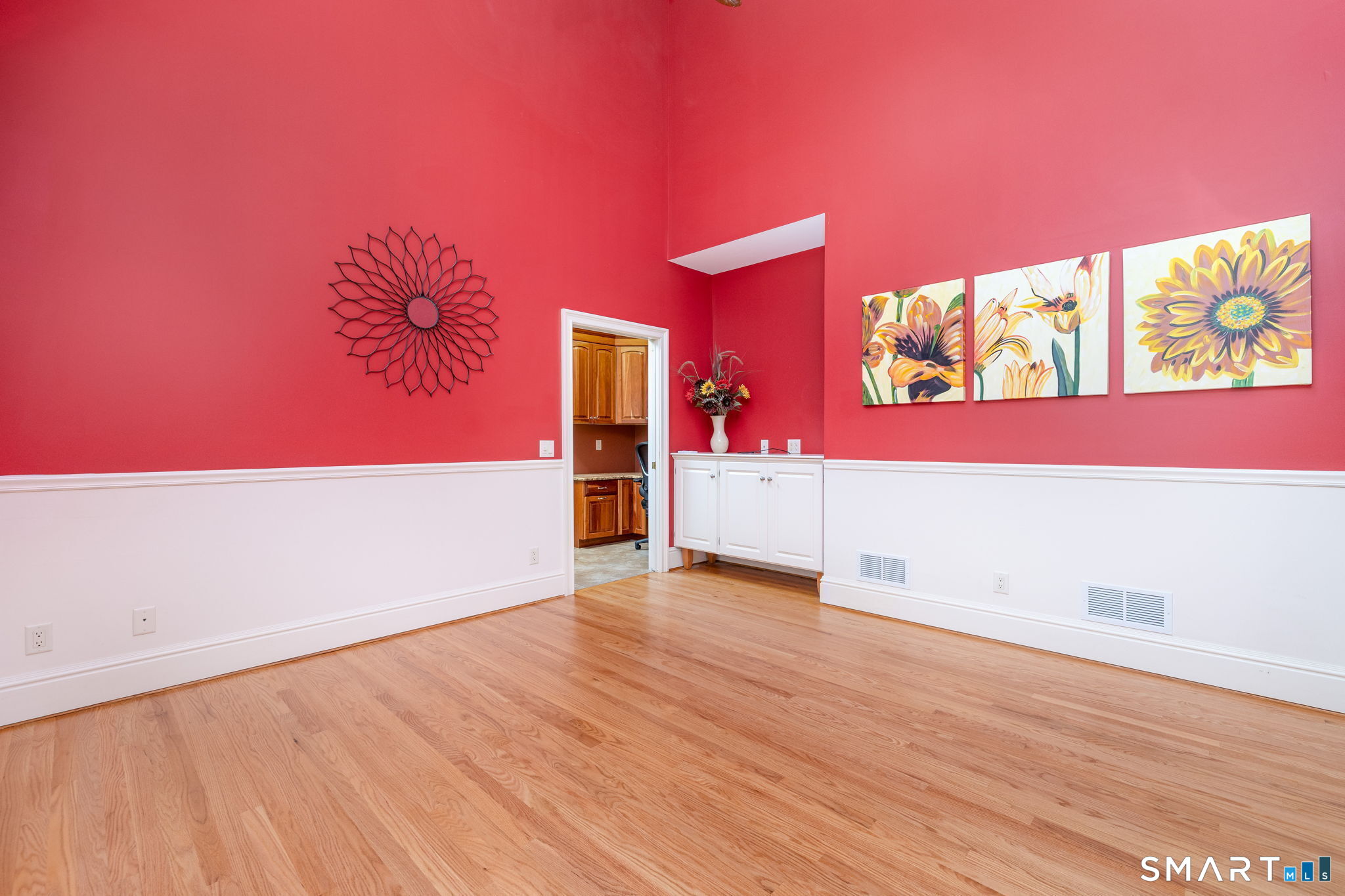The sunroom is located off of the kitchen through a pocket door, and the cabinets are used to home the whole-house audio controls.