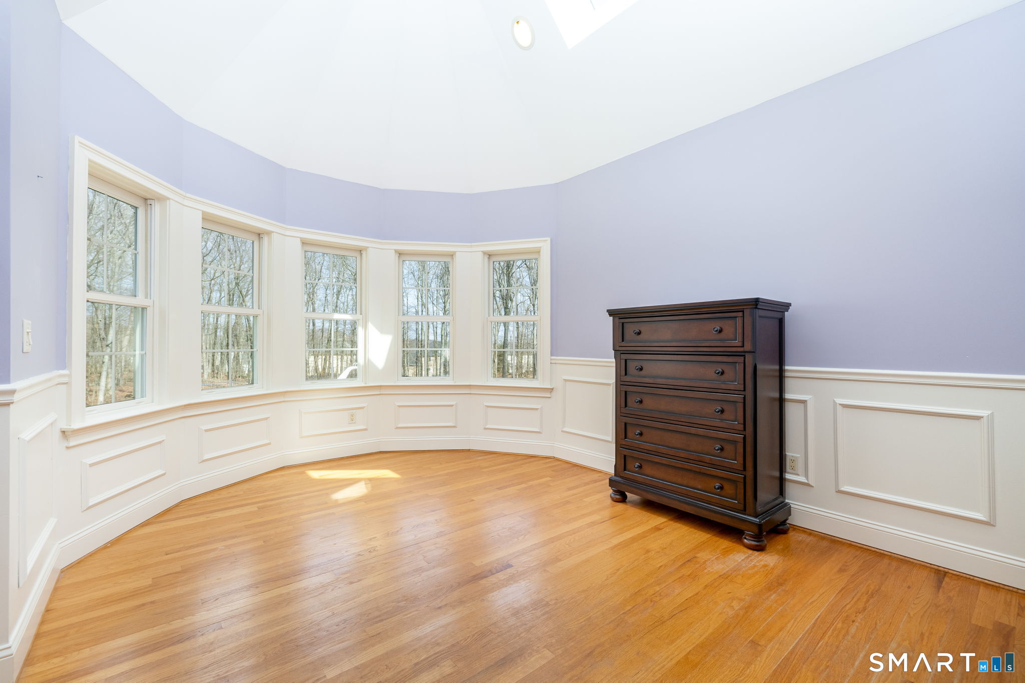 Large seating area in the primary bedroom suite overlooking the backyard.