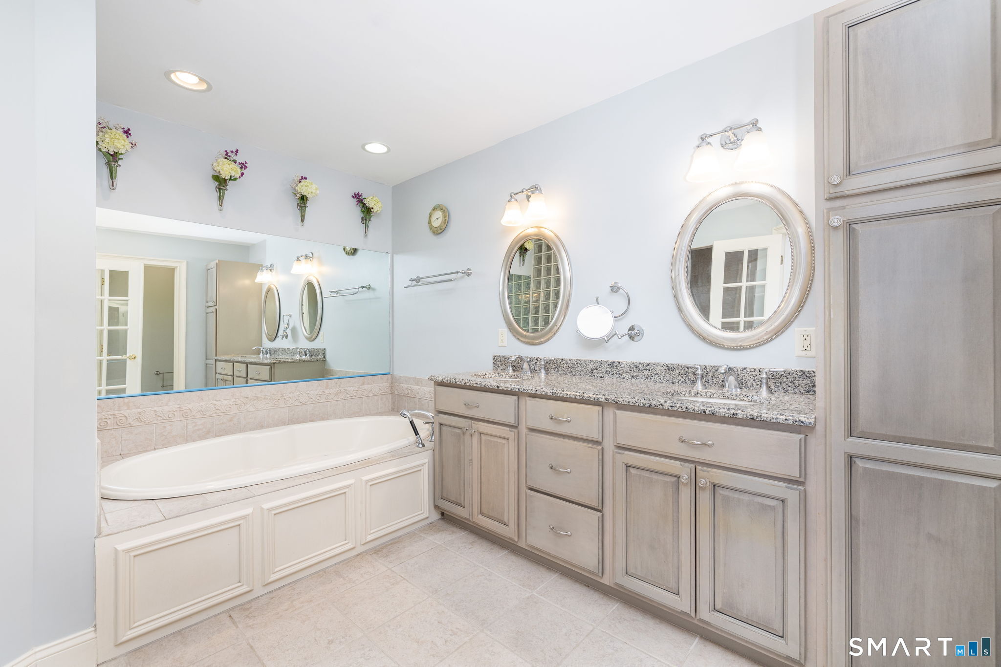This spacious bathroom has granite counters with double sinks, a jetted tub and separate walk-in shower, plus a separate water closet and great storage!