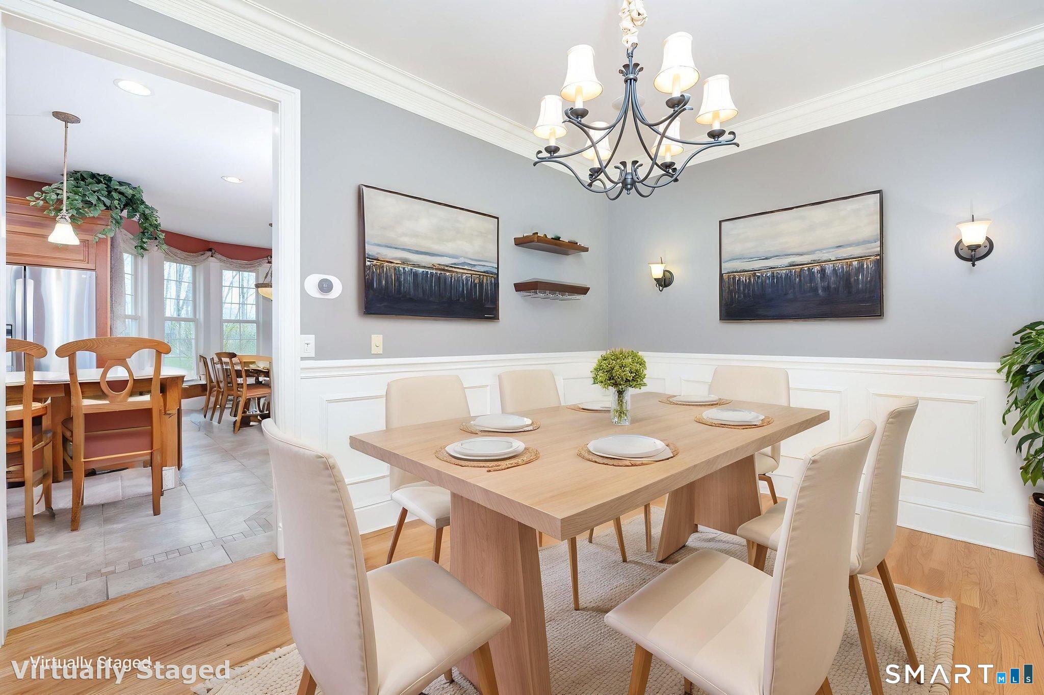 The 13'5' x 10'2" dining room features refinished oak floors, crown mouldings and panel wainscotting, for an elevated look.