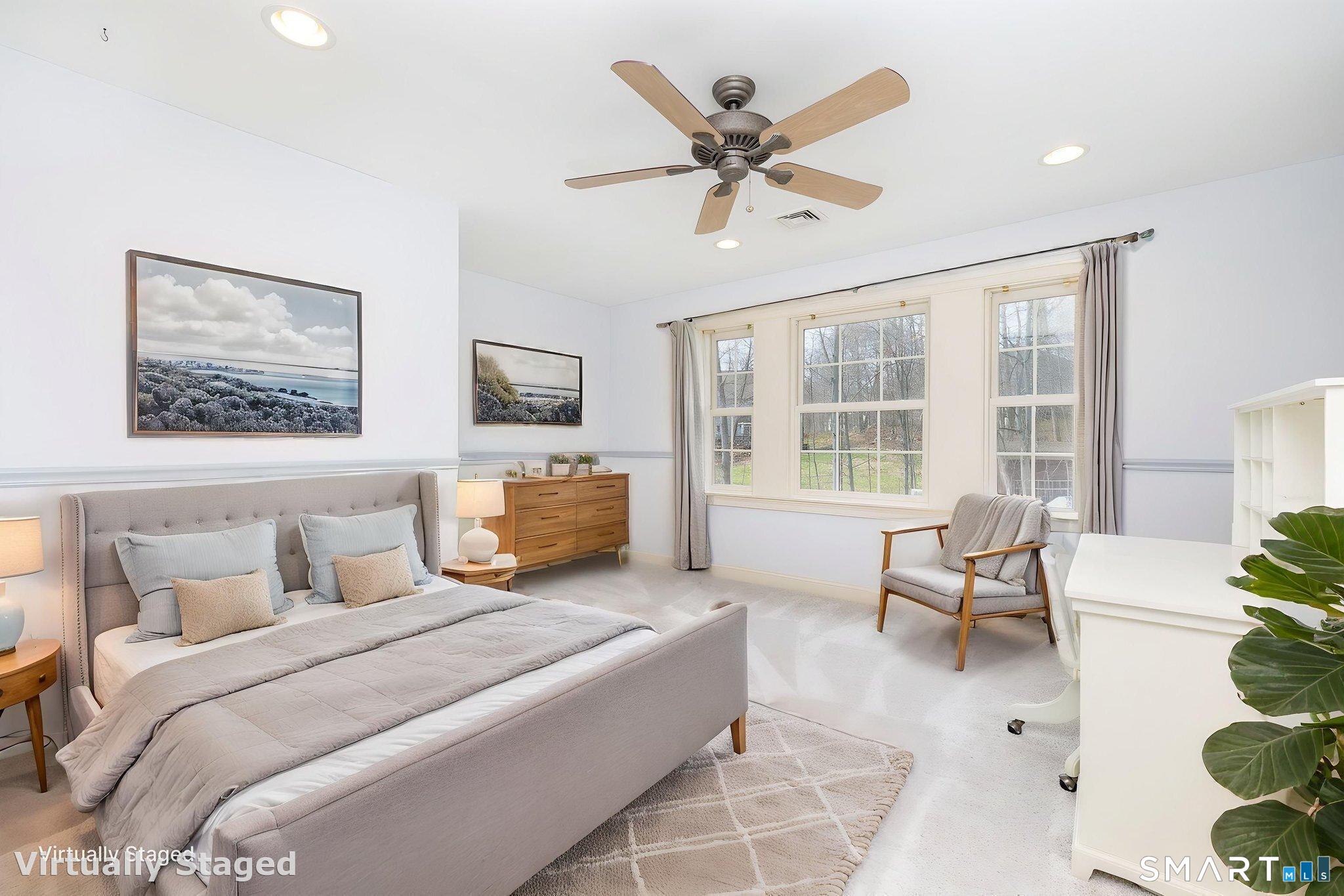 This 15'2" x 16'3" bedroom comes with a remodeled ensuite bathroom with new marble tile shower, walk-in closet, new carpeting in December 2025, chair rail, and a ceiling fan. The 3 windows provide great natural lighting!