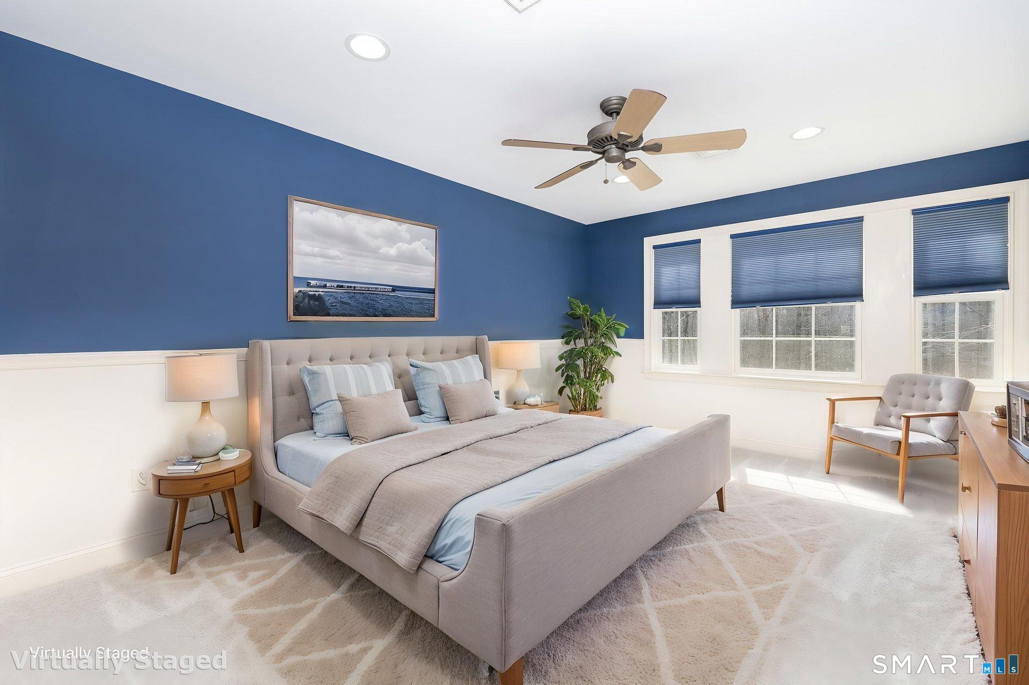 This charming 12'1" x 15'8" room features new carpeting in December 2025, chair rail, ceiling fan, generous closet, and a bank of 3 windows for great natural lighting.
