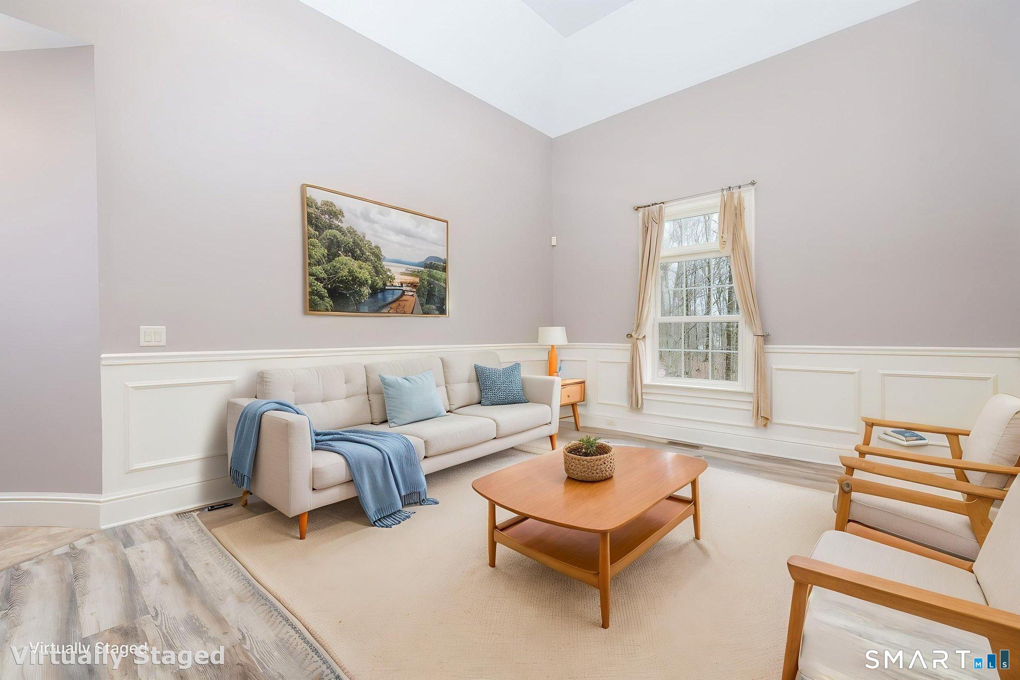 The 16' x 14'3" formal living room with tray ceiling and panel wainscotting. The house has a whole house audio system with speakers throughout the 1st floor.