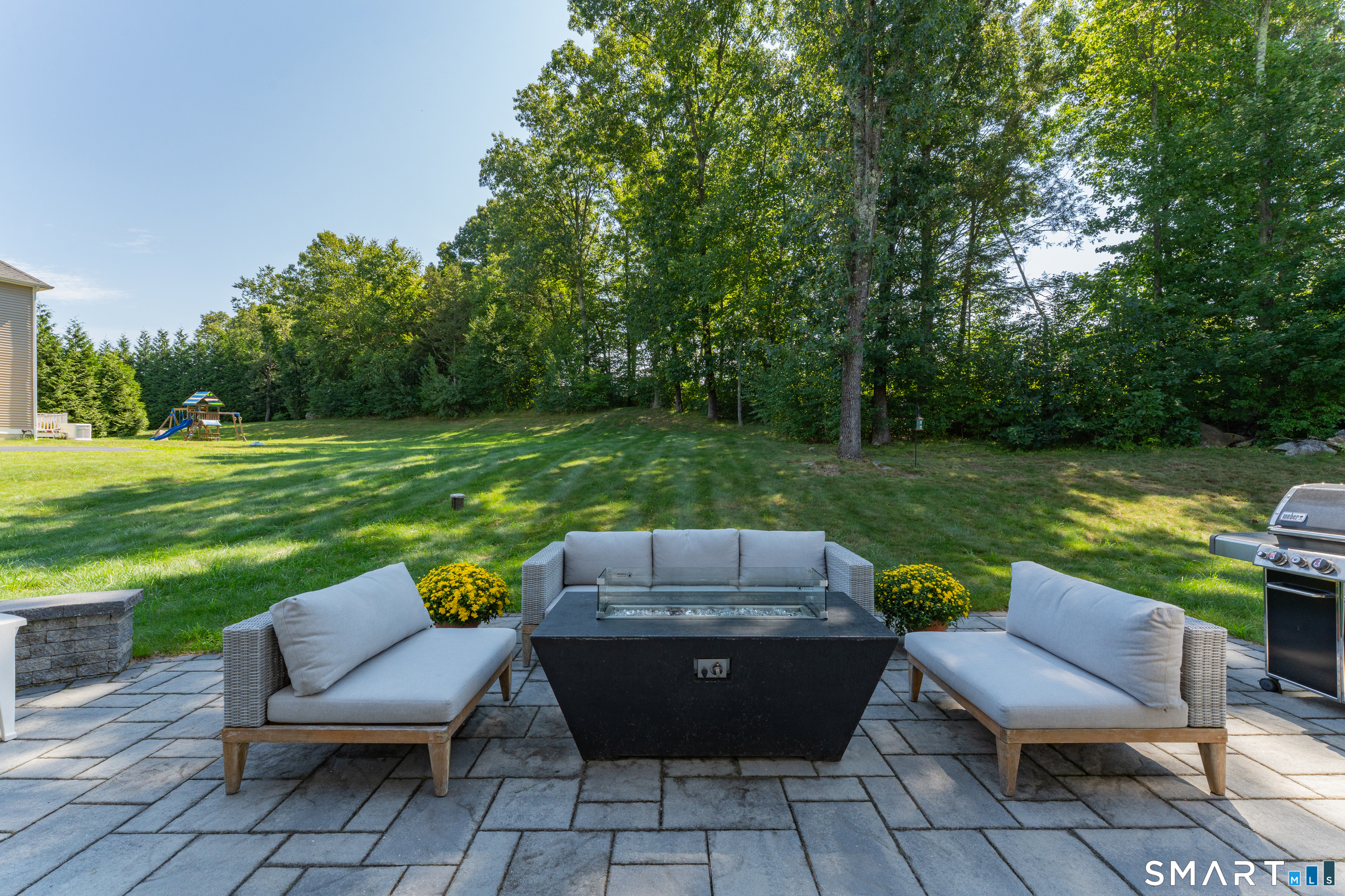 Fire table has propane and stays. Just add seating and you will want to use this area all of the time. Outdoor speakers allow you to set the mood.