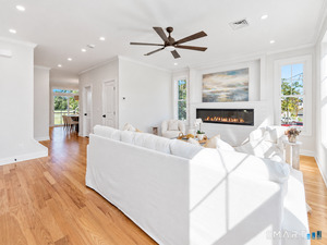 From the living room, enjoy views through the kitchen sliders to both the water and the beautiful natural marsh.