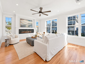 The generously sized living room features multiple windows, an abundance of natural light and beautiful water views.