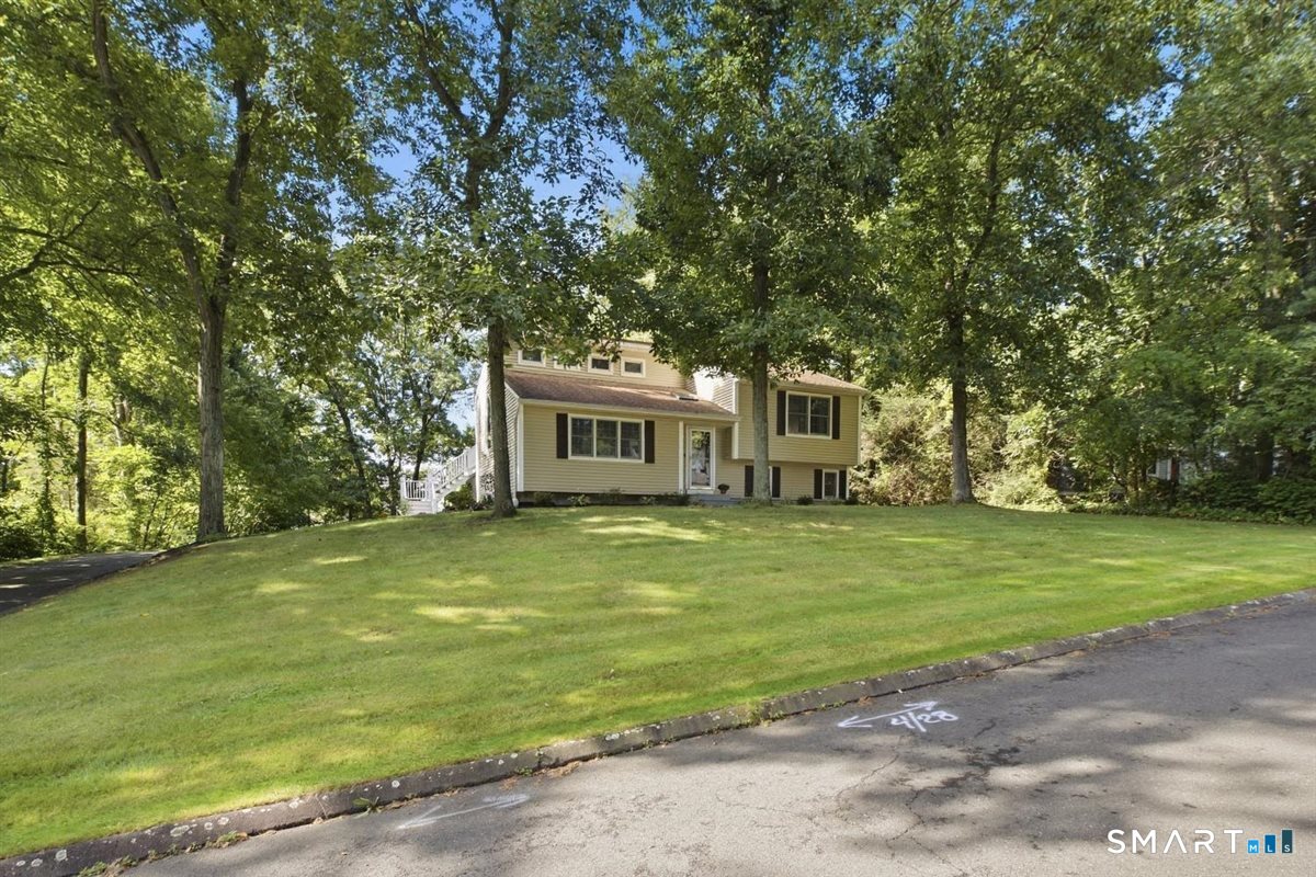 Welcome home, to this beautifully updated three-bedroom, two-bathroom contemporary, tri-level ranch that sits upon a beautiful parklike .74 acre lightly wooded lot in the charming Woodside acres community. Upon entering this home, you will find and inviting, open-air plan, with cathedral ceilings in both the living room and the remodeled kitchen. The kitchen flows seamlessly into the dining area and boasts granite countertops, stainless steel appliances with easy access to the large 14'x18' freshly painted composite deck that was added in 2020. The living room offers plenty of space and has an open, airy feeling. The updated lower level offers a generous space that could be used as an office or den, a bathroom/laundry room, and a third bedroom. This home won't last long, with it's beautiful park-like yard, updated siding and windows, newer (3500psi) foundation, remodeled kitchen and bathrooms. Schedule your showing today!