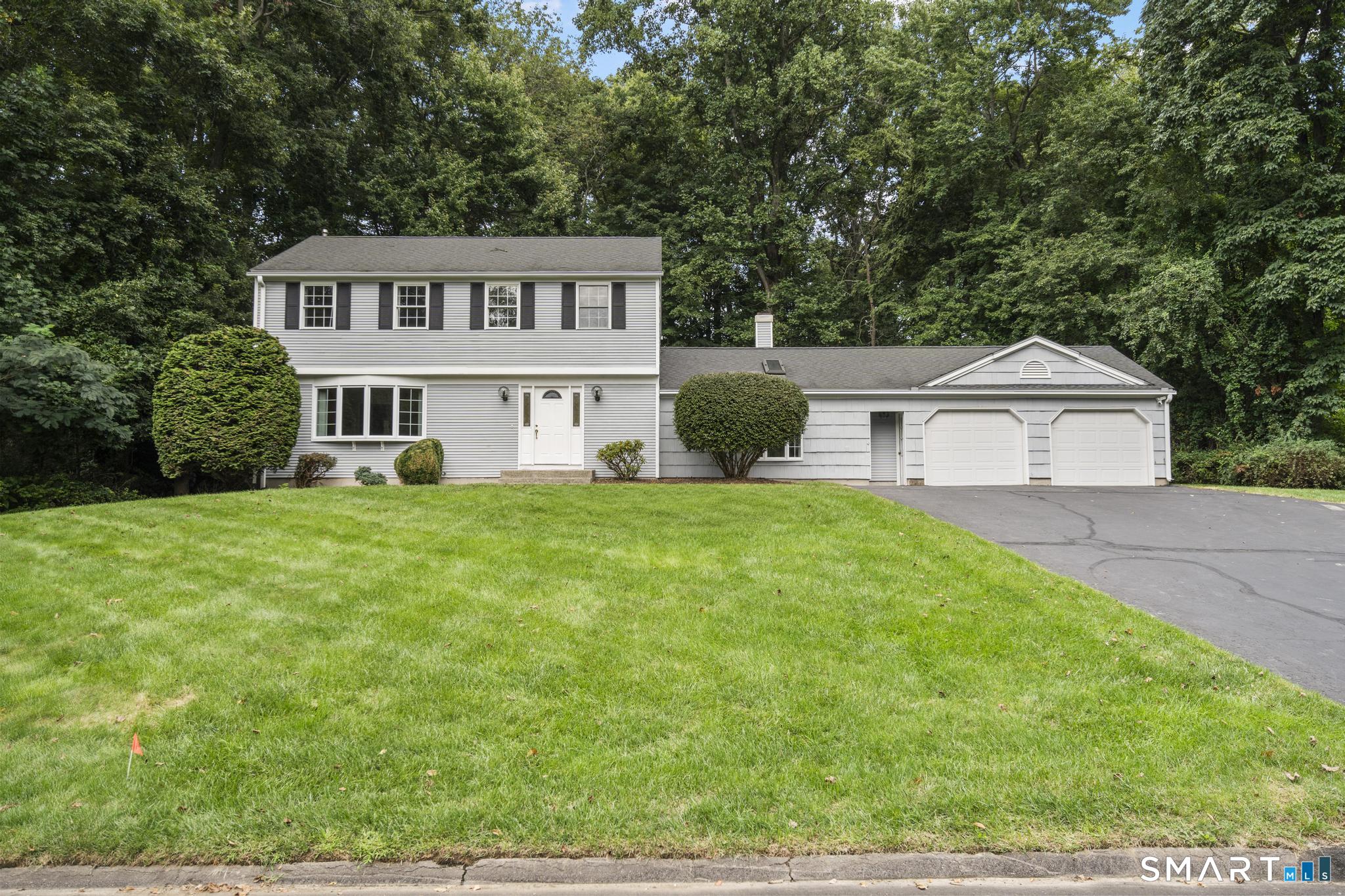 Welcome to this charming colonial-style home with 4 bedrooms, 2 full bathrooms, 1 half bathroom & approximately 2401 sq ft of finished living space. Nestled in one of the most desirable locations in Central Orange, this thoughtfully designed home is sited on 0.96 acres & balances traditional colonial styling & layout with the open design & comfort of contemporary design. From the front entry foyer, your led into a traditional living room featuring a large south-facing bay window through which sunlight flows. The adjoining dining room is elegant with chair rail trim & raised paneling & a bay window to view the private backyard. The dining room flows easily into a beautifully designed and laid out kitchen which features a pantry closet, lots of counterspace, ample cabinet storage, recessed lighting, a wet bar with a faucet for instant hot water, a peninsula perfect for food preparation and serving, and a sizeable eating space with unobstructed views of the private backyard through the sunroom oversize windows and skylights. The kitchen sunroom has a sliding door to a magnificent blue stone patio off the back of the house. The kitchen also steps down in the generously sized family room with a cathedral ceiling, gas fireplace, wide plank wood flooring and french doors (with screening) that also opens to the blue stone patio. On the 2nd floor of the home, is the primary bedroom with its own full bathroom, three additional bedrooms and a 2nd full bathroom (on the hallway).