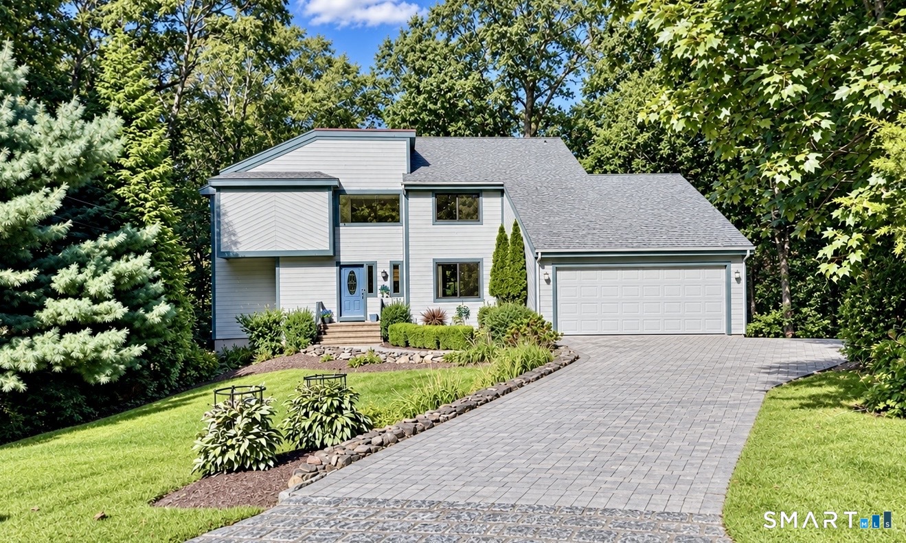 If you love space and contemporary homes, you will love this amazing bright home featuring cathedral ceilings wall of windows soaring high, 2 fireplaces. The large primary suit offers a fireplace and balcony situated on lovely lot with beautiful yard with sliders leading to back deck and patio. .