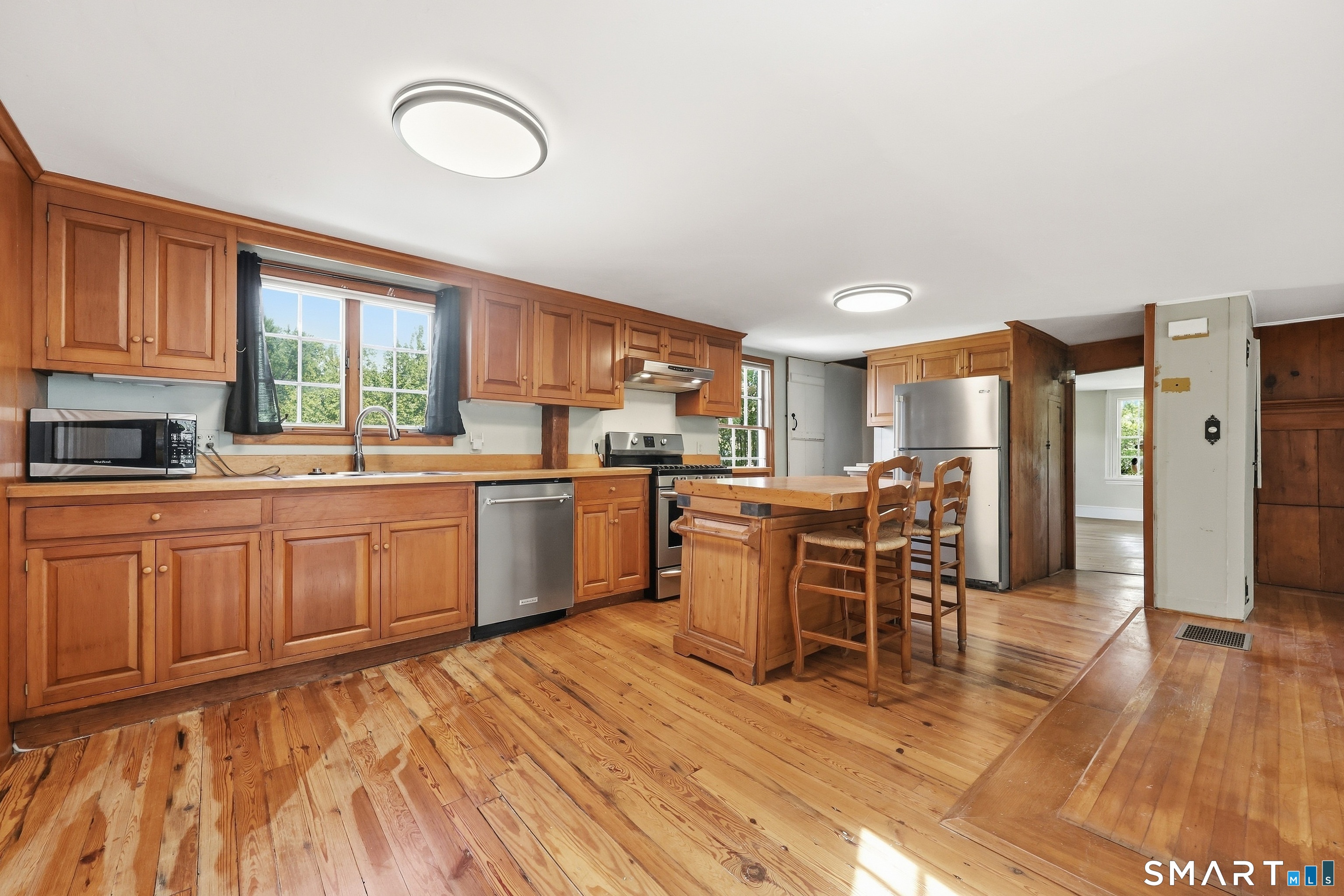 Spacious open concept kitchen with center island and stainless steel appliances.