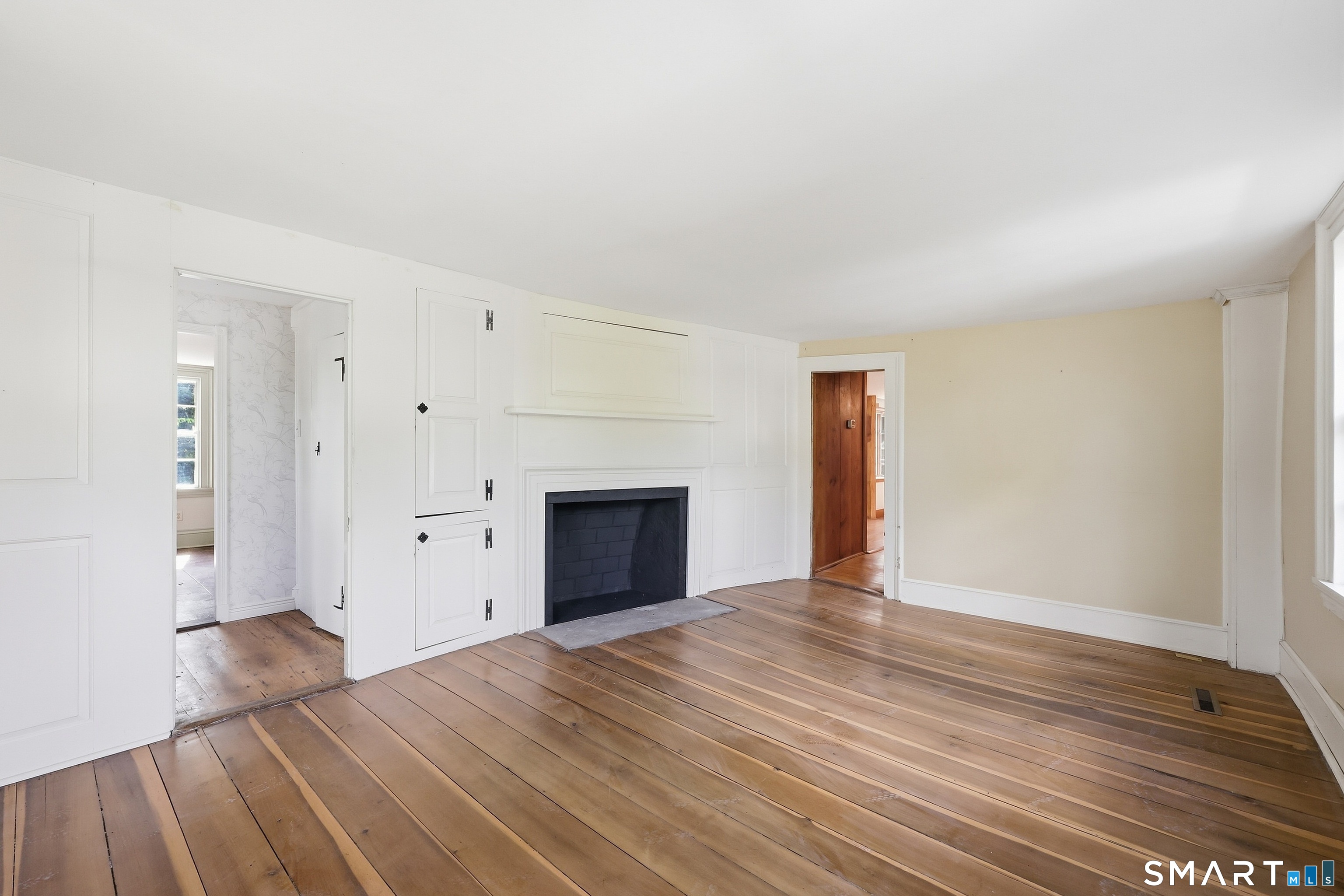 Warm hardwood floors stretch throughout all primary living spaces.