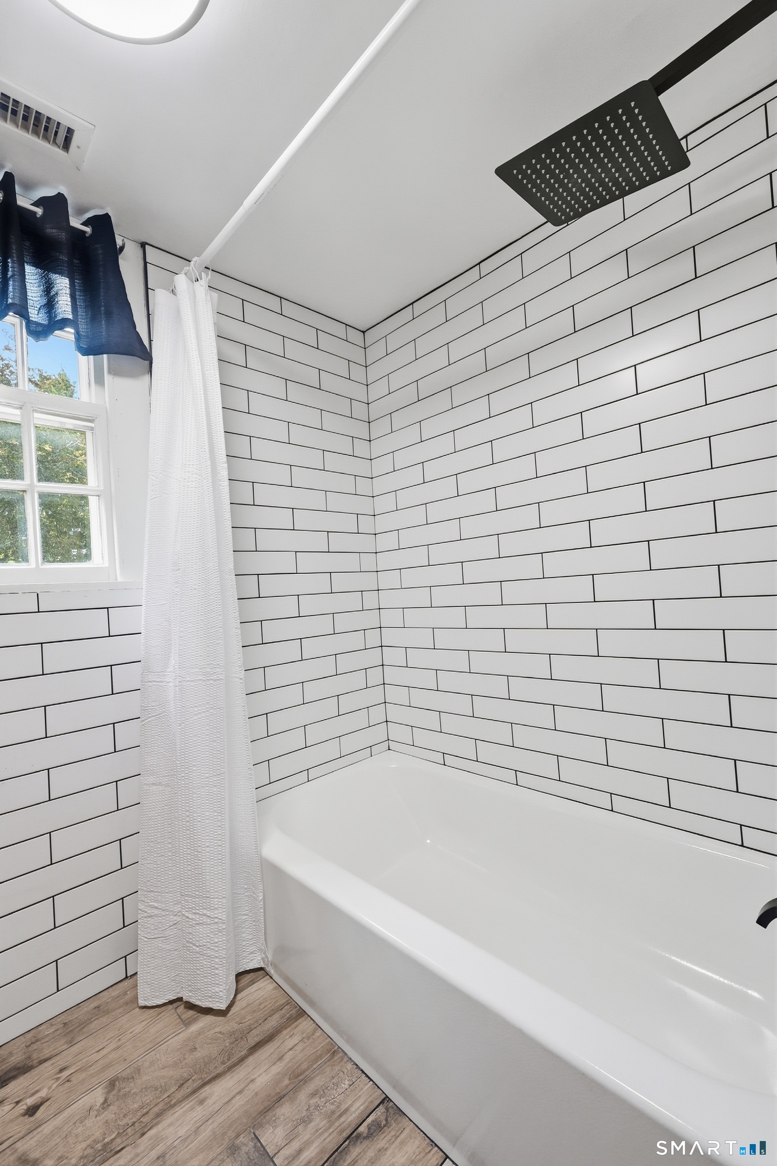 Upper Level Bathroom with tiled tub/shower combination.