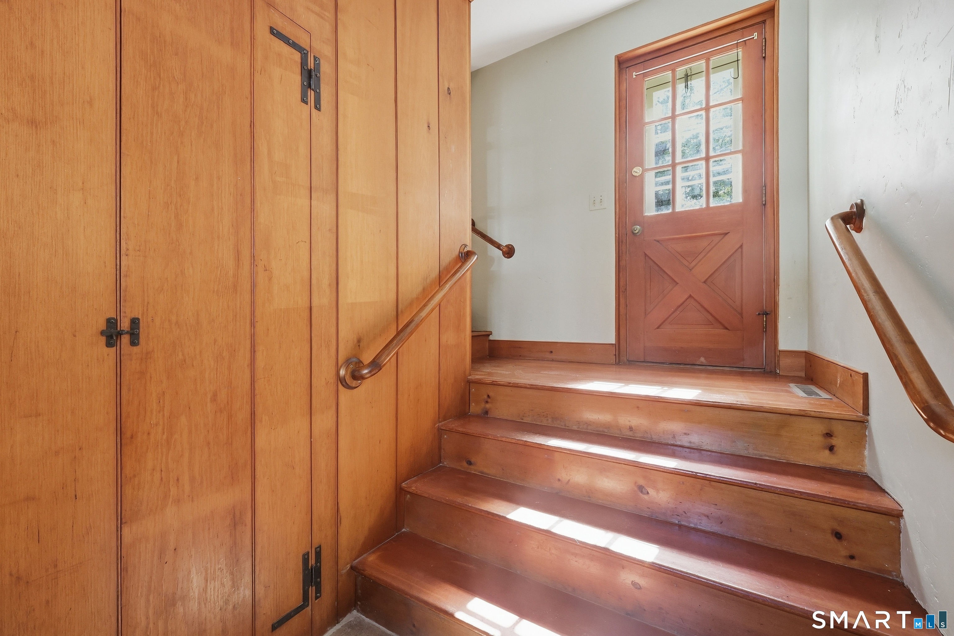 Side entry from driveway with coat closet and door leading out to patio.