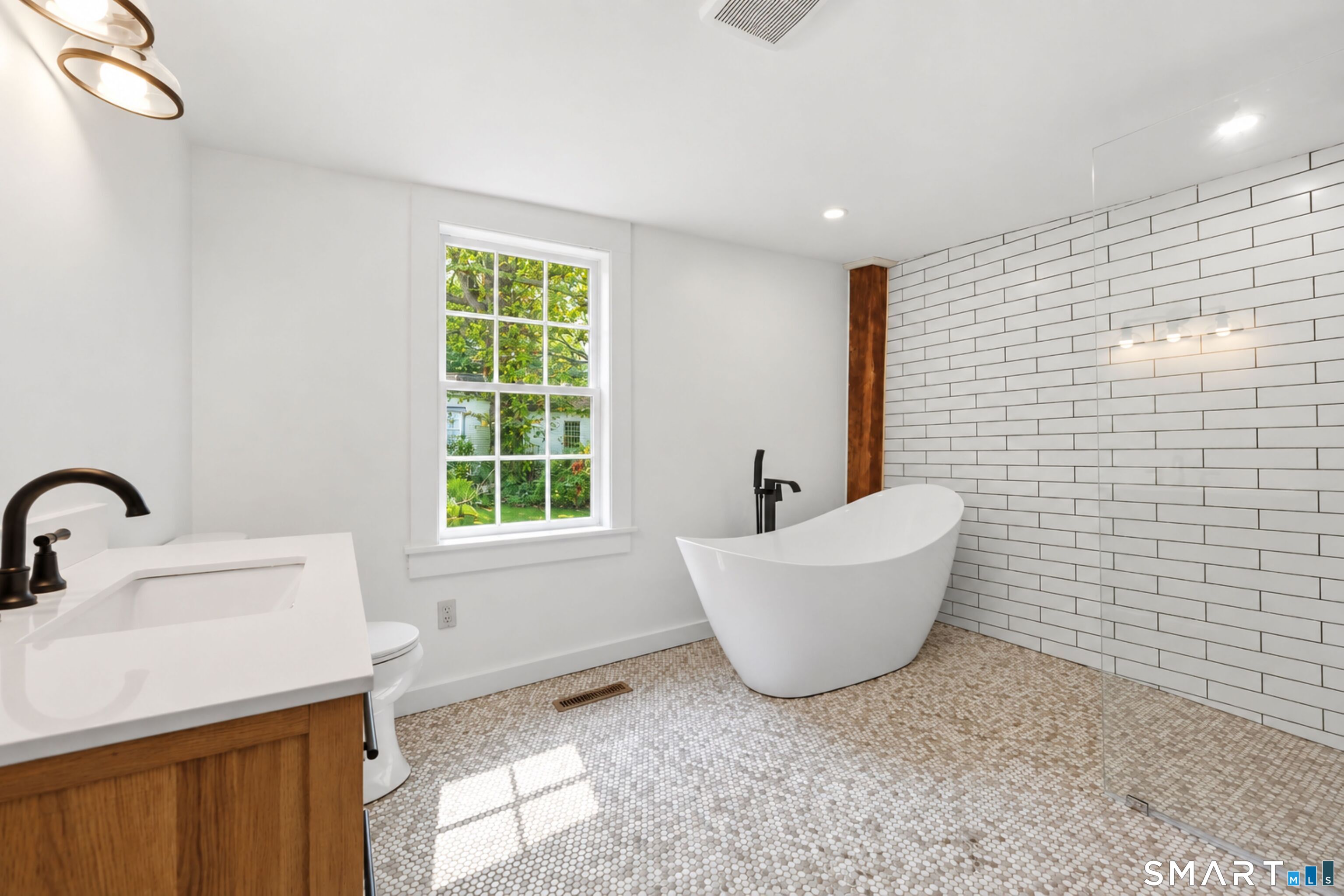 Brand NEW main level full bathroom with free-standing tub and walk-in shower.