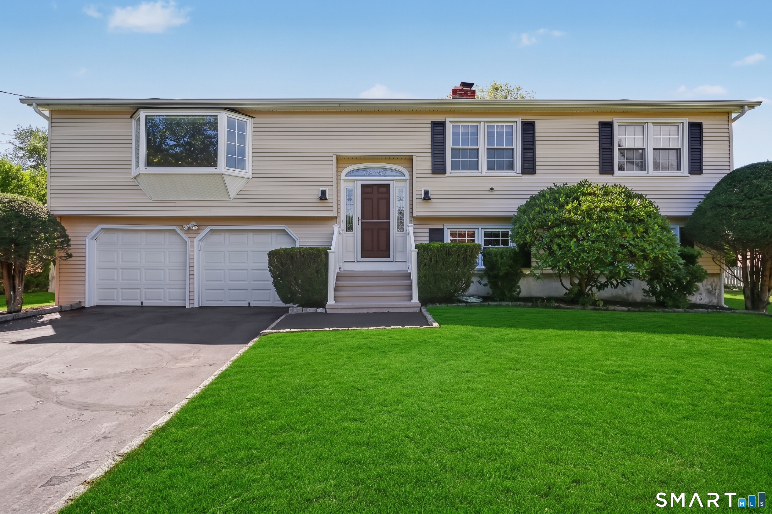 Fully updated and move-in ready, this home sits on a quiet, low-traffic street just minutes from both I-95 and the Merritt Parkway, an ideal setup for commuters who still want a peaceful neighborhood setting. You're right down the street from local schools and just minutes from area shopping. Freshly painted throughout, the home features refinished hardwood floors across the main level, a bright living area, and an eat-in kitchen with a newer sliding door leading out to the deck. Three bedrooms sit on the upper level, including a primary suite with its own private full bath. Downstairs, the finished lower level offers brand-new flooring and a versatile extra room that works perfectly as a home office, home gym, extra storage space, or even a 4th bedroom. Major mechanical updates include a new air handler, condenser, and a backup generator. The absolute highlight of the property is the incredible backyard. Completely flat, fully fenced, and wide open, it offers an exceptionally rare amount of usable space for play, pets, and outdoor entertaining right off the deck.