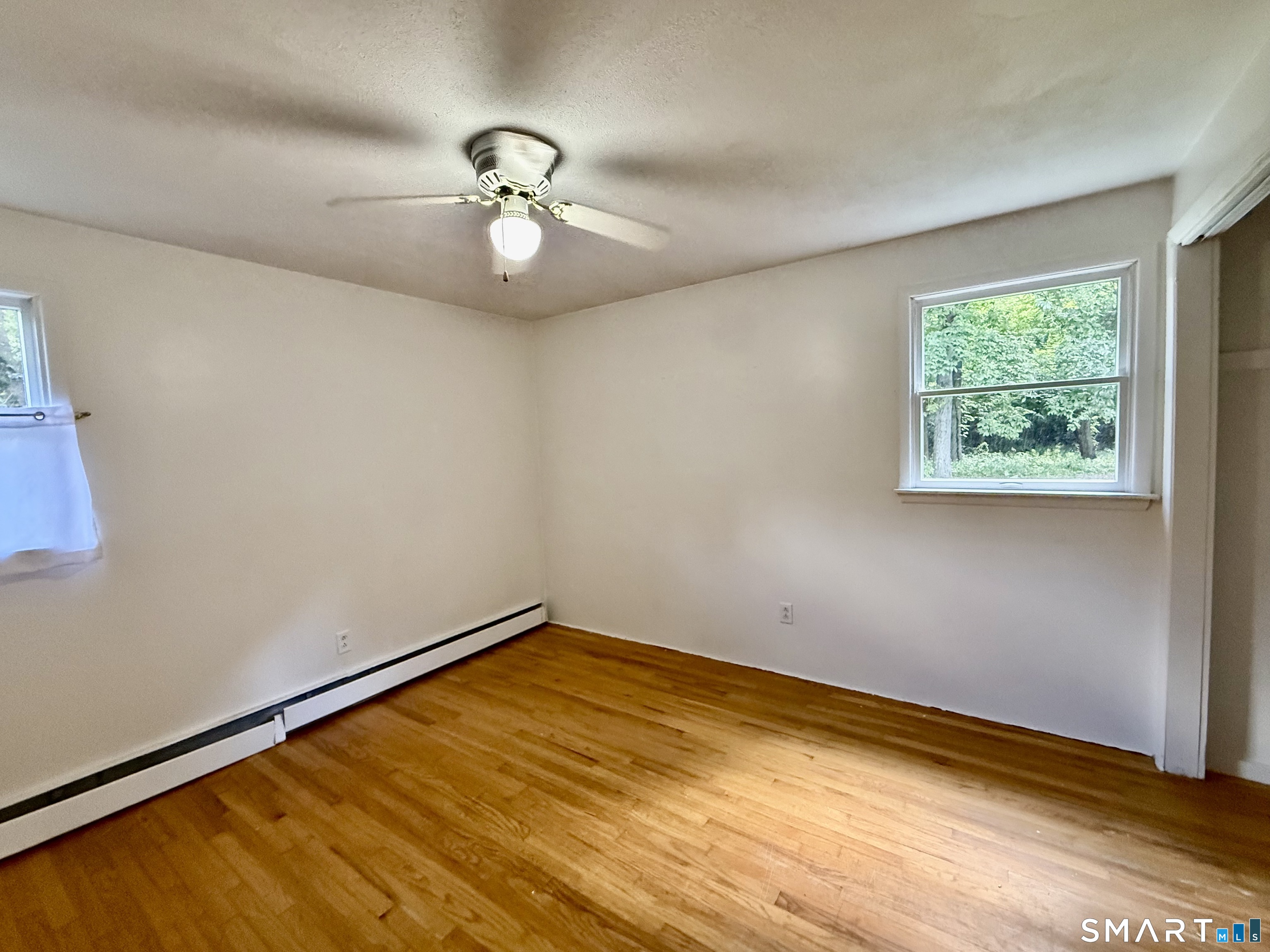 Bedroom with solid wood floors.