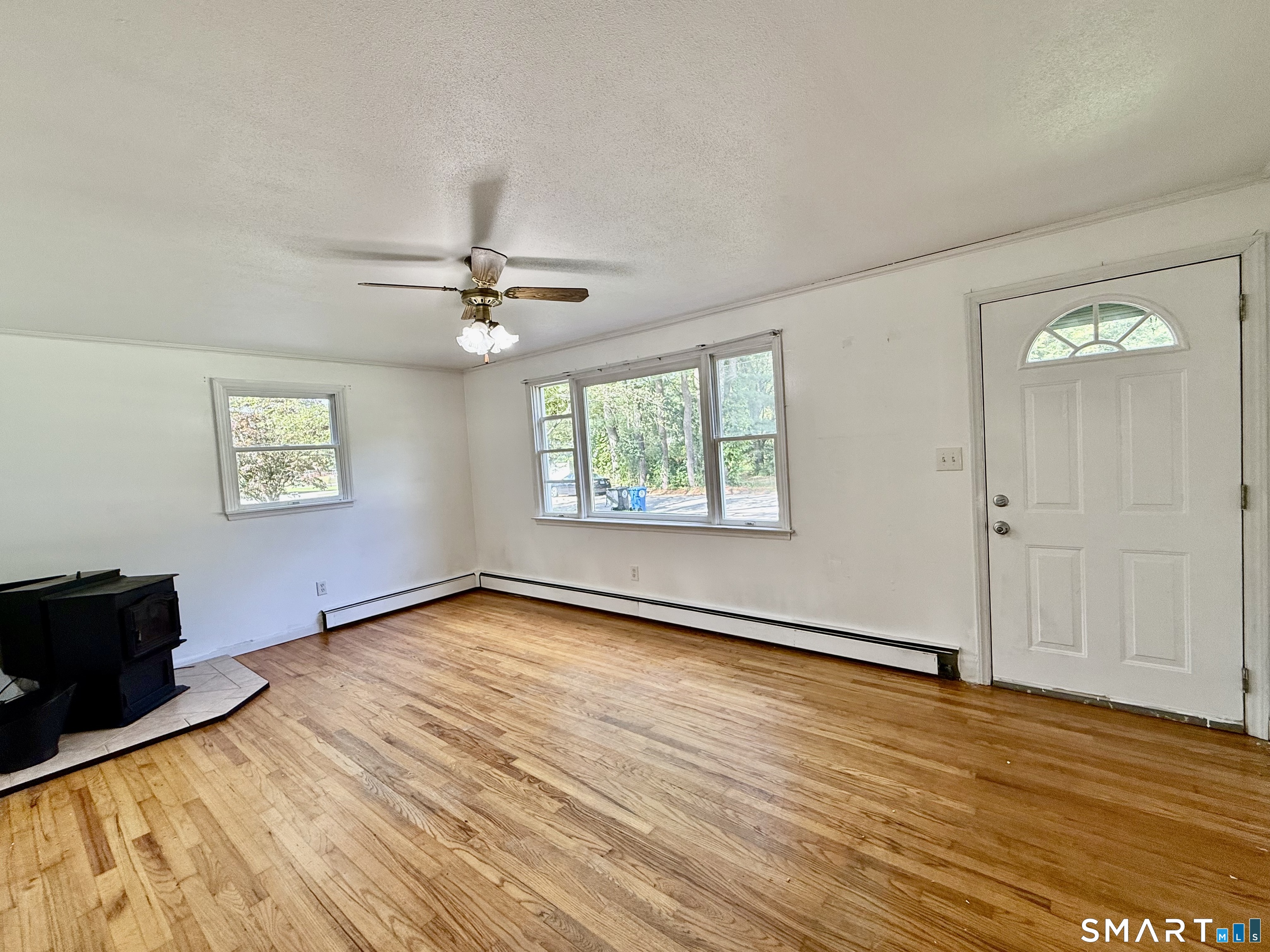 Living room with solid wood floors and pellet stove