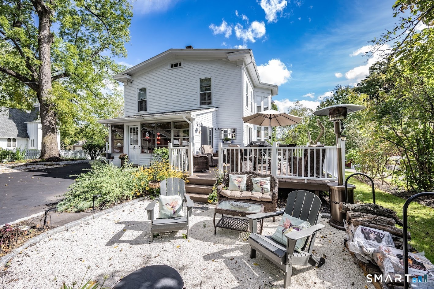 Inviting outdoor spaces include a spacious deck and gravel patio, perfect for relaxing, entertaining and enjoying the private backyard.
