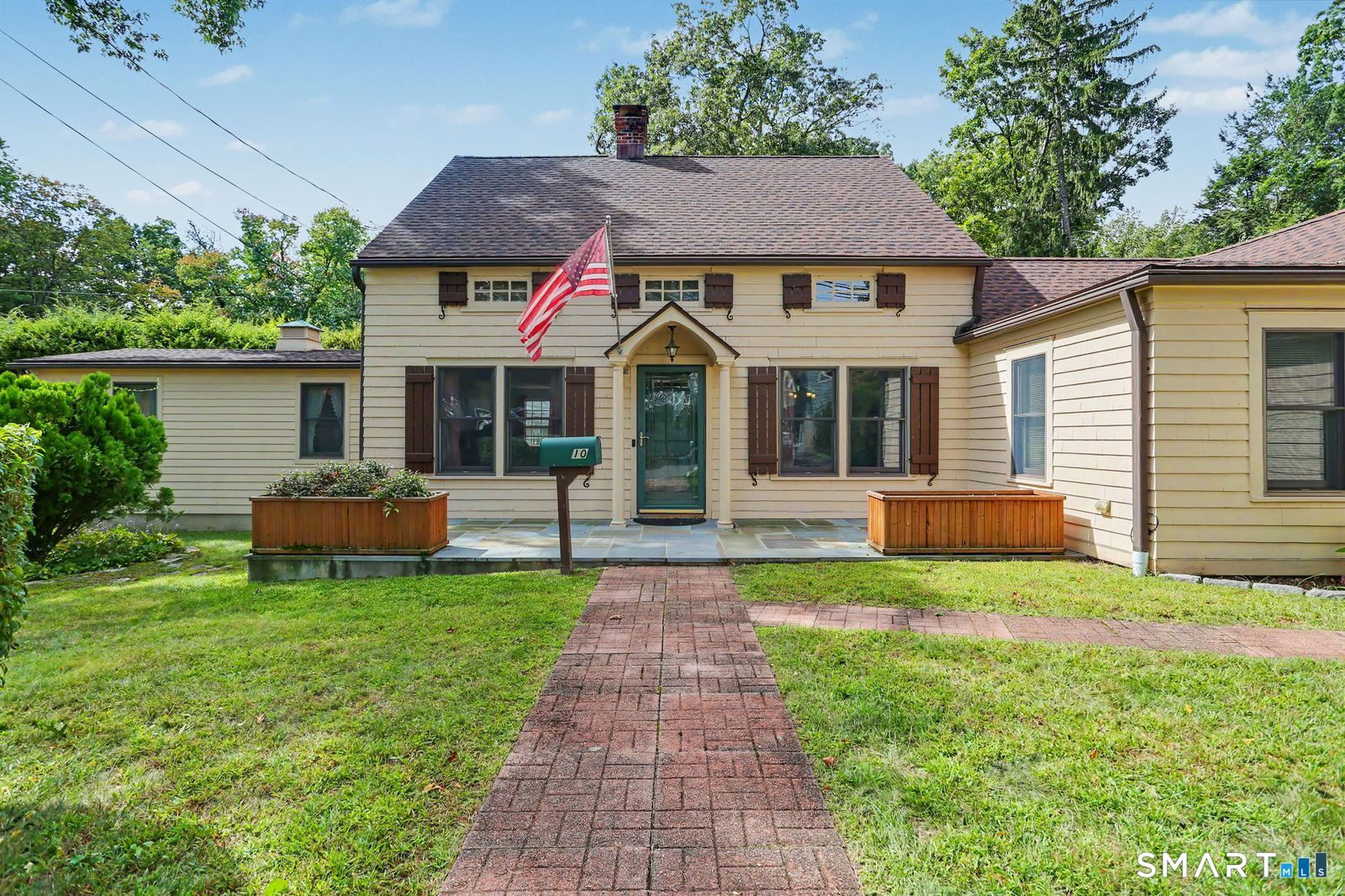 Welcome to 10 Hillwood Place, a charming 1928 Colonial in the desirable Silvermine neighborhood, offering 2,150 square feet of light-filled living space on a quiet 0.23-acre lot. Blending timeless character with modern convenience, this home features 4 bedrooms and 2.5 baths. The main level is designed for effortless living and entertaining, anchored by a convenient layout connecting the living room, dining room, and kitchen. A sunny breakfast room and a spacious family room both offer direct access to the rear deck, creating an easy indoor-outdoor flow. The main floor also hosts a private primary suite complete with multiple closets and a large primary bathroom with a whirlpool tub--perfect for one-level living or in-laws. There is a convenient home office, laundry room, and an attached one-car garage on the main level. Upstairs, three additional well-sized bedrooms with hardwood floors share a central full bath, providing a quiet and dedicated sleeping space. Step outside to enjoy a wonderful deck, a charming porch, and a small, private backyard - ideal for relaxing or weekend gatherings. All of this is located within a short distance to the highways, with Angelo's Specialties and great restaurants and shops around the corner--and with Calf Pasture Beach rights. With central air conditioning, extra basement space for storage and a fantastic location near everything Norwalk has to offer, this delightful home is ready for its next chapter!