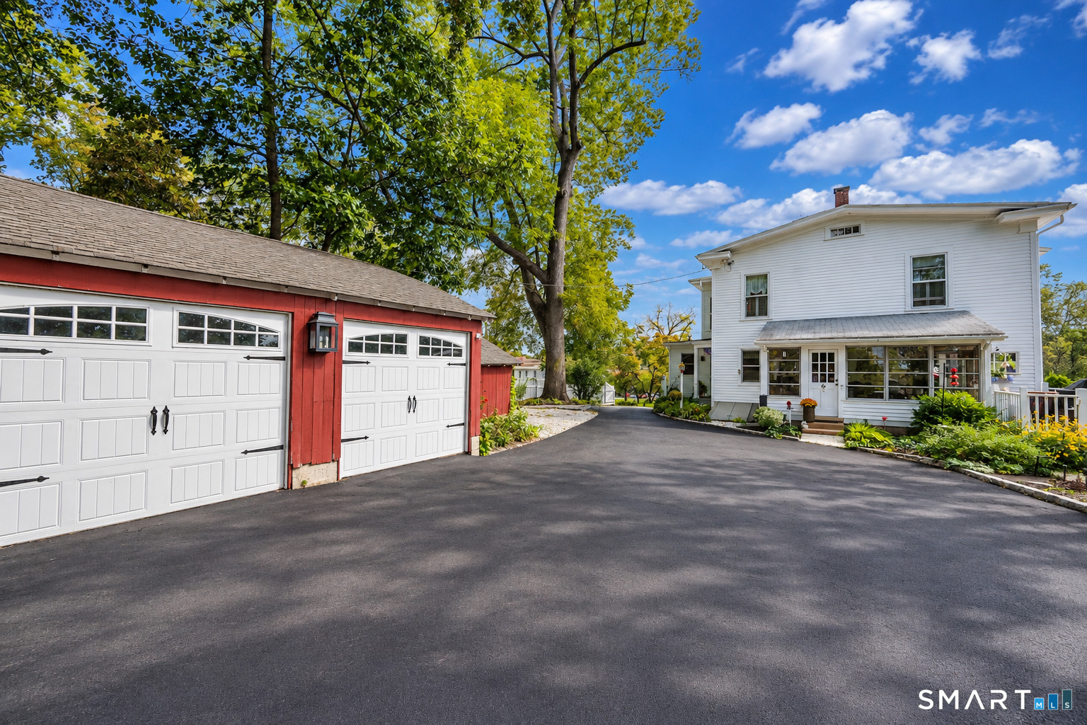 Detached garage, expansive paved driveway and plenty of parking complement the home's historic character with everyday practicality.