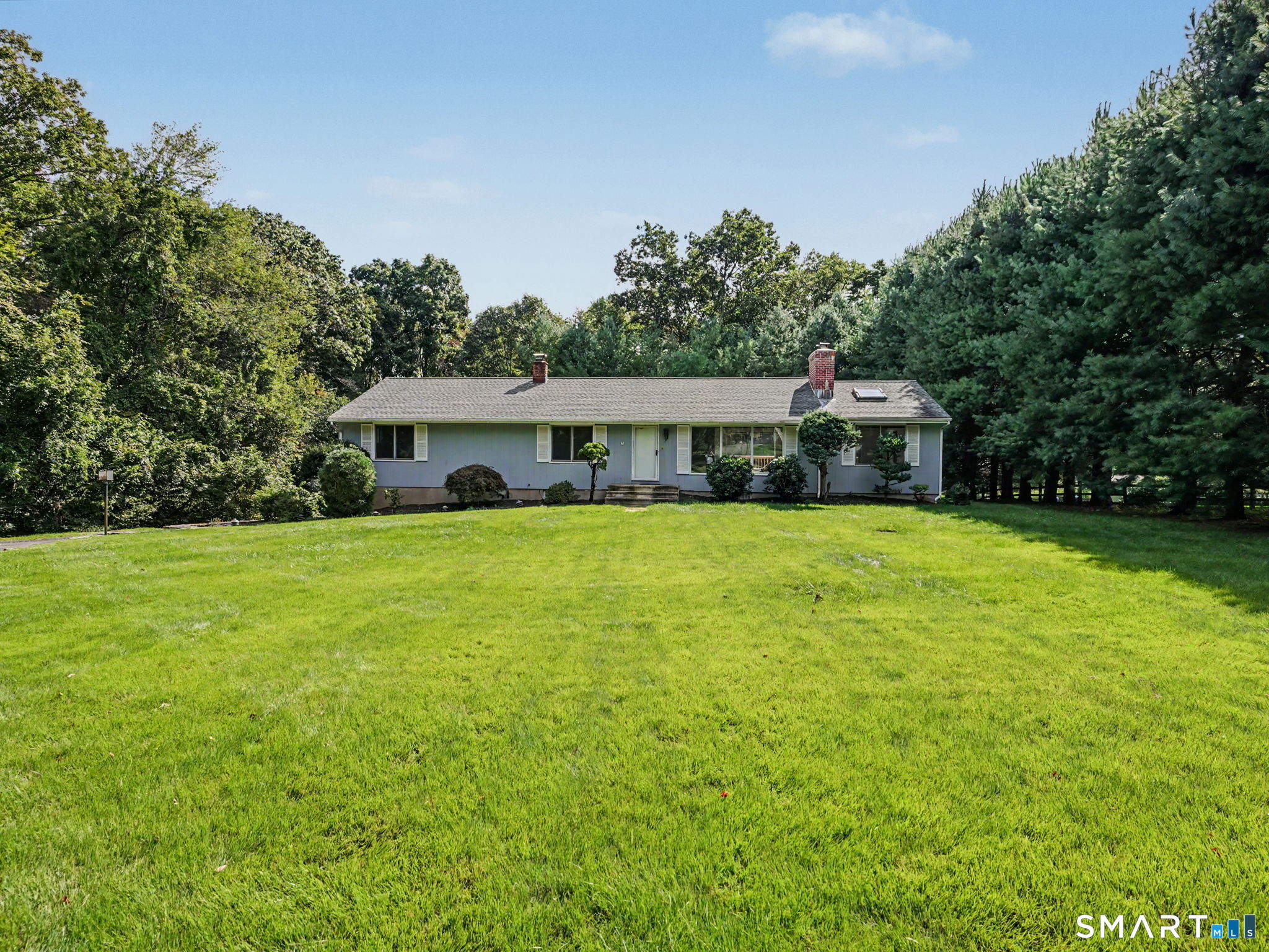Welcome to 29 Weatherbell Drive, a classic 1960 ranch-style home located in Norwalk's desirable Cranbury neighborhood, offering 2,044 square feet of comfortable living space with 4 bedrooms and 2.5 bathrooms on an expansive 0.9-acre lot. One-level living doesn't get more spacious than this. The main floor showcases an open-concept living area where the kitchen, dining room, living room, and family room flow together seamlessly, complemented by a warm family room featuring vaulted ceilings with skylights and a large deck overlooking the property. Tucked away are four spacious bedrooms and two full bathrooms, perfectly separated from the active living areas. The finished lower level adds incredible flexibility with a sprawling playroom with a second fireplace, a bonus room, half bathroom, laundry and pantry, and a convenient basement garage. Step outside into your own private backyard oasis, complete with an inviting in-ground pool and a spacious stone patio for the ultimate summer barbecues and weekend lounging. All of this is located in desirable Cranbury, only a few minutes from Cranbury Park, the Merritt Parkway, and more-complete with access to Calf Pasture Beach. This spacious gem is ready to welcome you home!