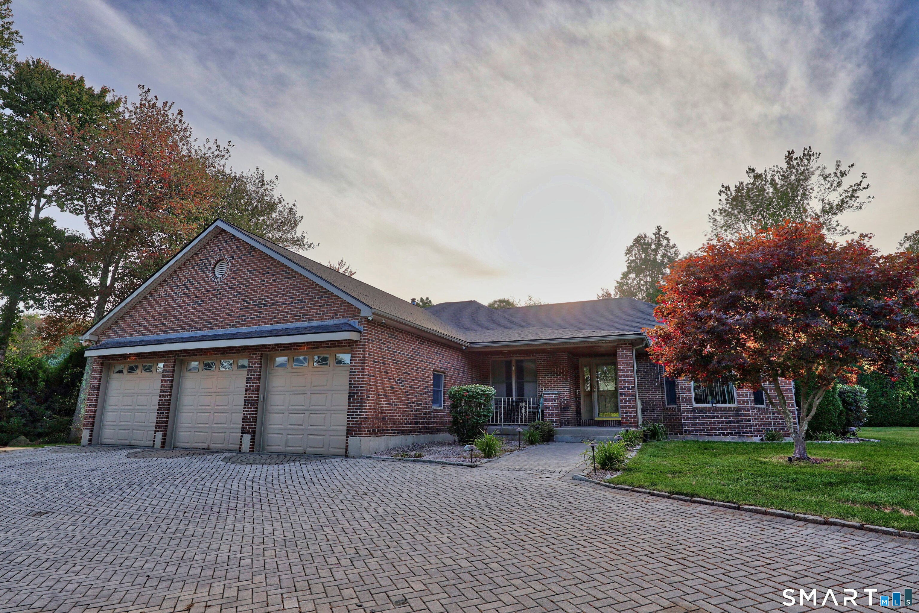 Your own private retreat awaits! Set on a beautifully appointed acre at the end of a cul-de-sac, this impressive brick ranch offers an exceptional blend of everyday comfort, entertaining space, and resort-style amenities. With approximately 4,400 square feet of finished living space across two levels, there is room for everyone to spread out, gather, and enjoy.  The main level welcomes you with an inviting open layout centered around a bright living room with a propane fireplace and a spectacular kitchen designed for those who love to cook and entertain. A 6-burner Wolf range anchors the kitchen, while the adjoining three-season porch provides a wonderful extension of the living space. The spacious primary suite offers a private retreat, complete with a generous bath featuring dual vanities, a Jacuzzi tub, and separate shower.  The lower level takes entertaining to another level with a second kitchen, comfortable living area, bar, pool table, phone booth, and half bath. A separate entrance adds flexibility, making this level ideal for guests, extended family, recreational use, or other possibilities.  Step outside and discover your own backyard getaway. An inground pool, putting green, hot tub, stamped-concrete patio, and irrigation system create an environment made for summer gatherings and relaxing weekends at home. The property also offers an impressive circular brick driveway, three-car attached garage, and an additional two-car detached tandem garage.