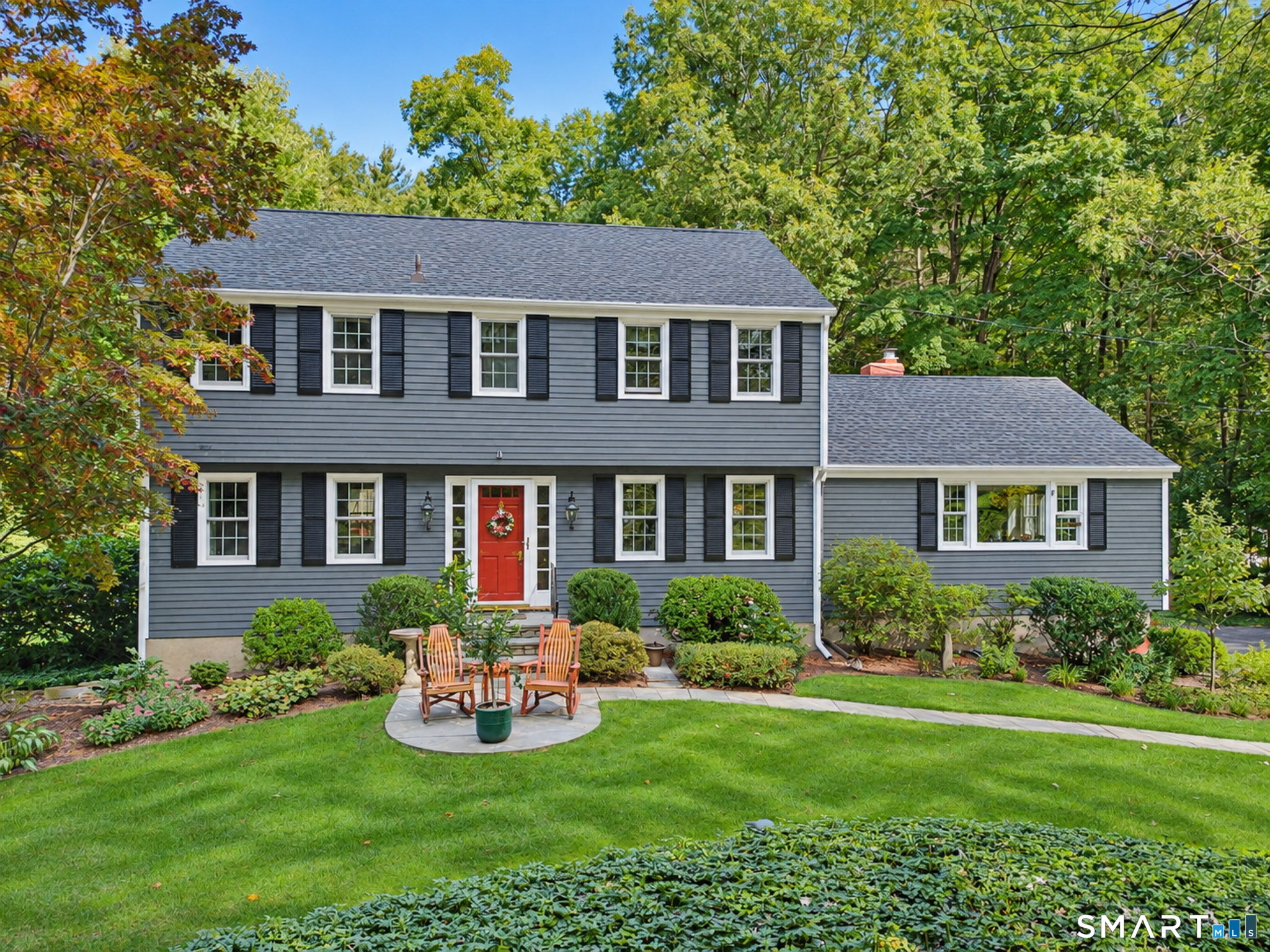 Backing to McLean Game Refuge & nestled on 2 beautifully landscaped acres with perennial gardens, lush lawn & stone walls, this lovingly maintained & updated 4 bedroom Colonial offers a private, peaceful setting & true pride of ownership. A pretty walkway welcomes you to the foyer, which leads to a front-to-back living room with fireplace, crown molding & wood floors and a spacious dining room with wood floors. The remodeled eat-in kitchen features granite counters, stainless appliances, abundant cabinetry & wood floors and opens to the inviting family room with fireplace & new mini split (2026). French doors lead to a huge 3-season room overlooking the lovely backyard & natural surroundings. An updated half bath & laundry complete the first floor. Upstairs are 4 generous bedrooms with wood floors, including the primary with remodeled private bath, plus a remodeled main bath. Central air serves the 2nd floor (2016). The lower level offers a workshop & plenty of storage. Additional features include a 2-car garage, large shed, attic fan & generator hookup. Updates include roof 2010, replacement windows (3 in 2012, 4 in 2014 & 16 in 2016), newer well pump, Nothing to do but unpack & enjoy this special Simsbury home!