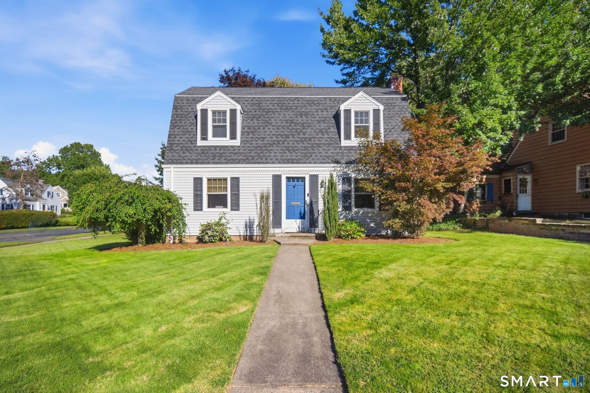 Charming, updated Dutch Colonial in a convenient Newington location offering the best of both worlds! Enjoy the accessibility of Main Street while the driveway, located on a quiet side street, provides a welcoming neighborhood feel. The exceptionally private, level backyard offers a peaceful retreat with mature trees, a fire pit, and plenty of space to relax or entertain. This 3-bedroom, 1.1-bath home features hardwood floors throughout much of the home and a flexible floor plan. The spacious kitchen offers maple cabinetry and granite countertops and opens to the dining room with a charming original corner built-in. The inviting living room features a stacked-stone fireplace and plenty of room to entertain. A first-floor family room, office, or playroom opens to the composite deck and beautifully secluded backyard. Upstairs are three bedrooms and an updated full bath. Recent improvements include a new wall AC unit, electric meter, GFCI outlets, rebuilt fire pit, and washer/dryer. Major updates include thermopane windows (2018), boiler (2015), oil tank (2018), roof (2015), and composite deck (2011). Low-maintenance vinyl siding, an oversized one-car garage, sidewalks to Newington Center, and easy access to West Hartford and I-84 complete the package.