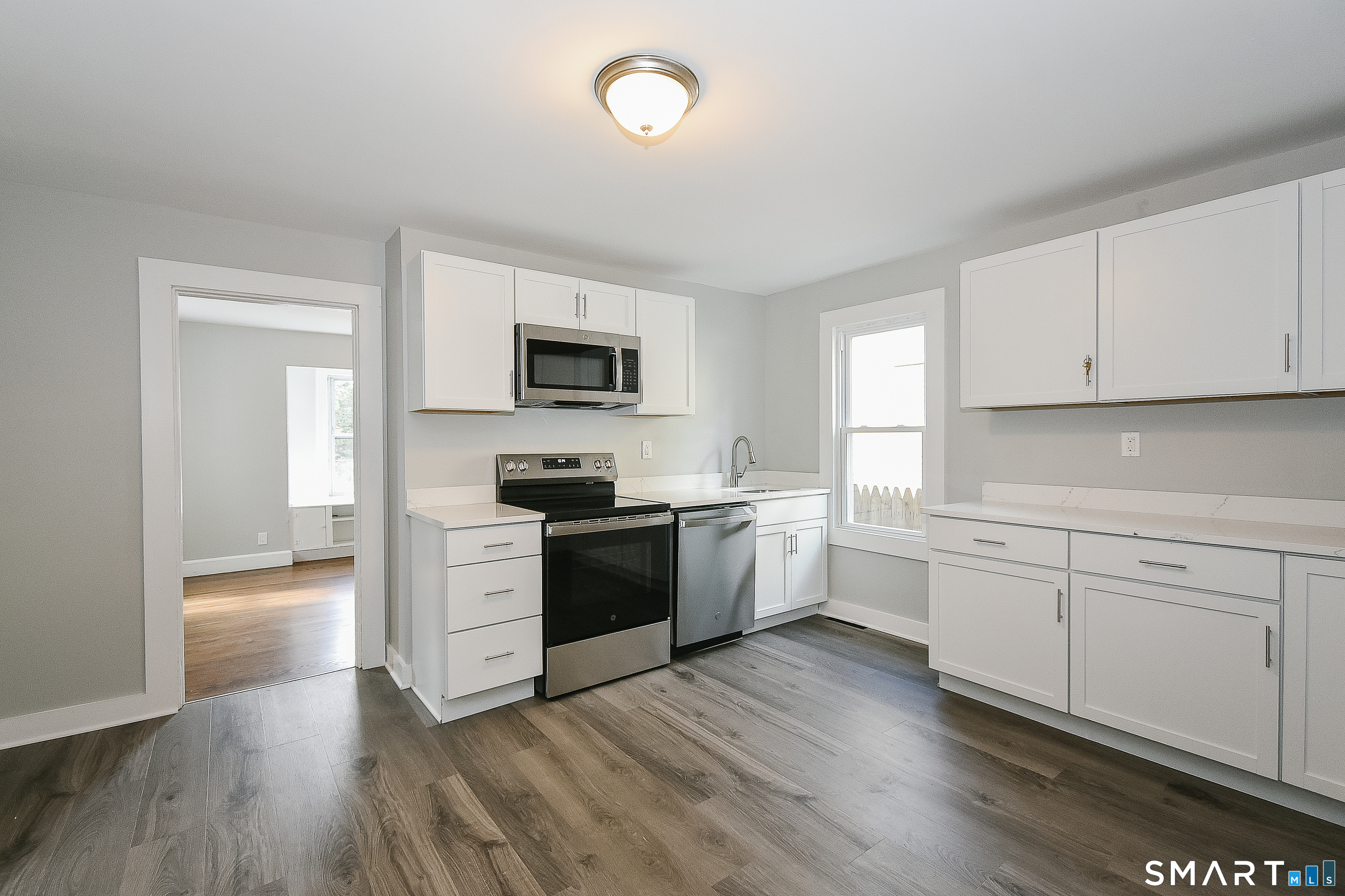 Move right into this beautifully renovated New Haven home! The property has been thoughtfully updated throughout while maintaining its classic character. The bright interior features fresh paint, refinished hardwood flooring, updated flooring, and abundant natural light. The refreshed kitchen offers white cabinetry, quartz-style countertops, stainless steel appliances, and plenty of workspace. An updated full bath features a tiled tub/shower surround and modern finishes. Outside, enjoy fresh siding, composite entry steps, off-street parking, and a surprisingly spacious, private backyard. Conveniently located with easy access to downtown New Haven, shopping, restaurants, highways, and area amenities. A turnkey home ready for its next owner!