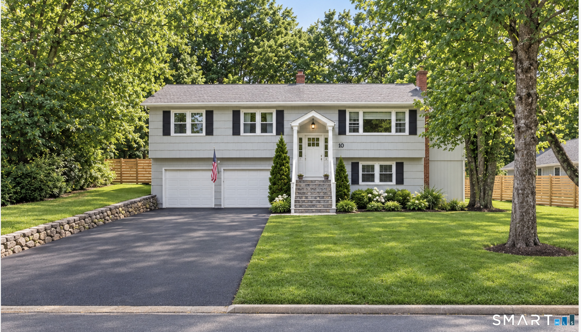 Welcome to 10 Grumman Avenue, nestled in the heart of Norwalk's highly desirable Cranbury neighborhood! This beautifully maintained raised ranch seamlessly blends thoughtful updates, inviting living spaces, and exceptional outdoor amenities. At the heart of the home is a custom chef's kitchen, designed with granite countertops, stainless steel appliances, two ovens, abundant cabinetry, and Anderson windows. The main level features hardwood floors, central air, fresh paint, an updated full bath, and a built-in Ring security system add comfort, style, and peace of mind. A standout feature is the impressive main-level addition, offering an expansive dining and gathering area perfectly suited for hosting holidays or celebrations! The finished lower level provides even more versatile living space, complete with a cozy fireplace, convenient half bath, access to garage, and walkout access to the backyard. Step outside to your own private retreat, where a professionally landscaped backyard offers a fully fenced yard, spacious deck, and custom-built stone patio with an outdoor fireplace-the perfect backdrop for summer evenings, outdoor entertaining, or simply unwinding at home. Additional highlights include a two-car garage, new hot water heater, and newer roof, providing added value and peace of mind. Ideally located just minutes from Calf Pasture Beach, the Westport town line, shopping, restaurants, parks, and I-95. Don't miss your opportunity to make this Cranbury gem your own!