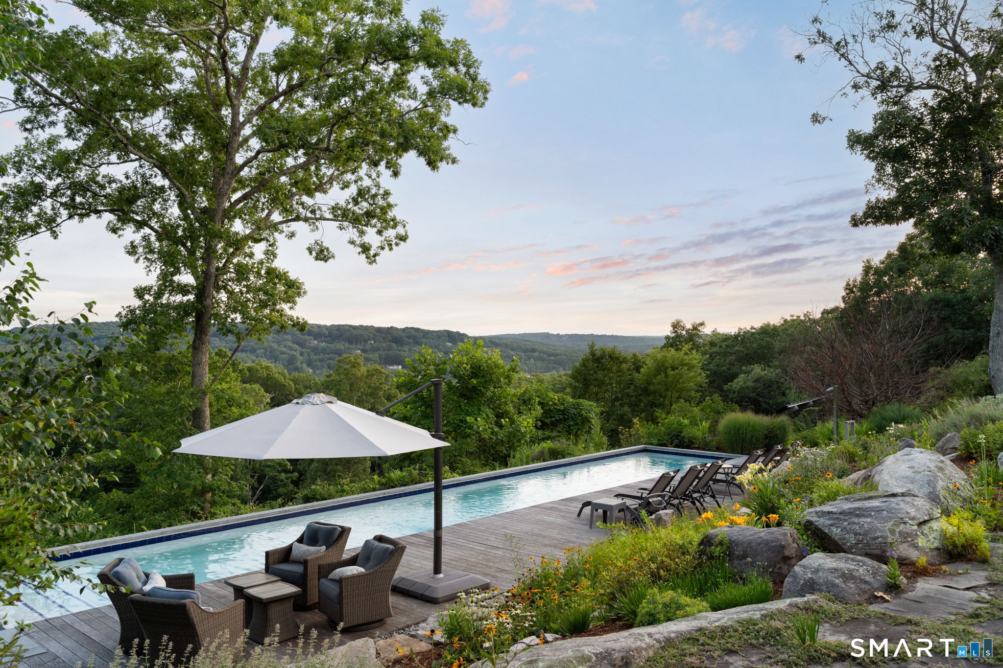 Poolside living surrounded by native stone and gardens