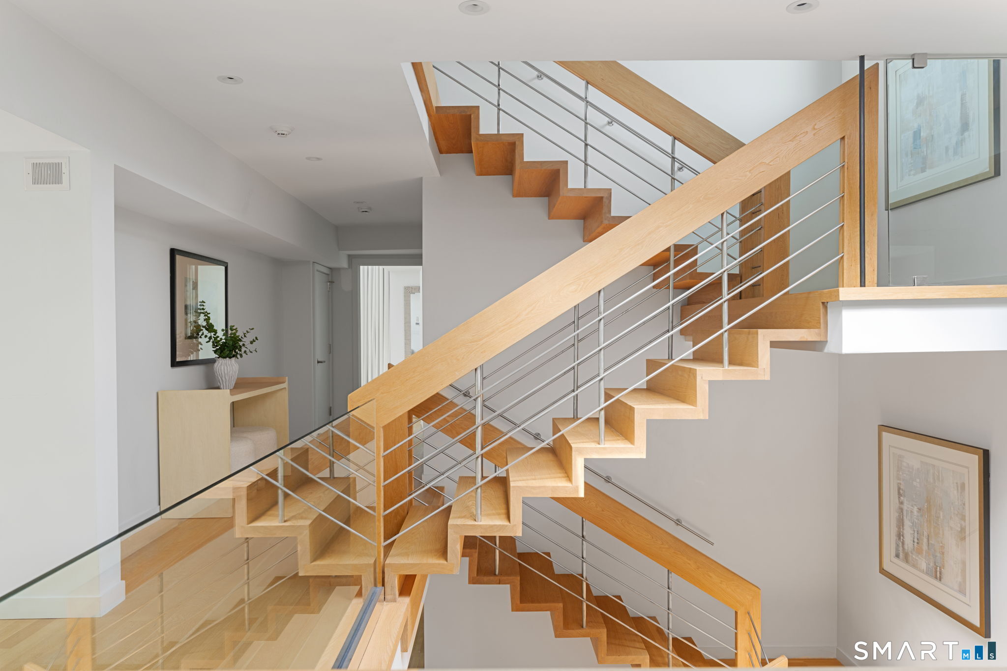 White oak staircases connect all three levels