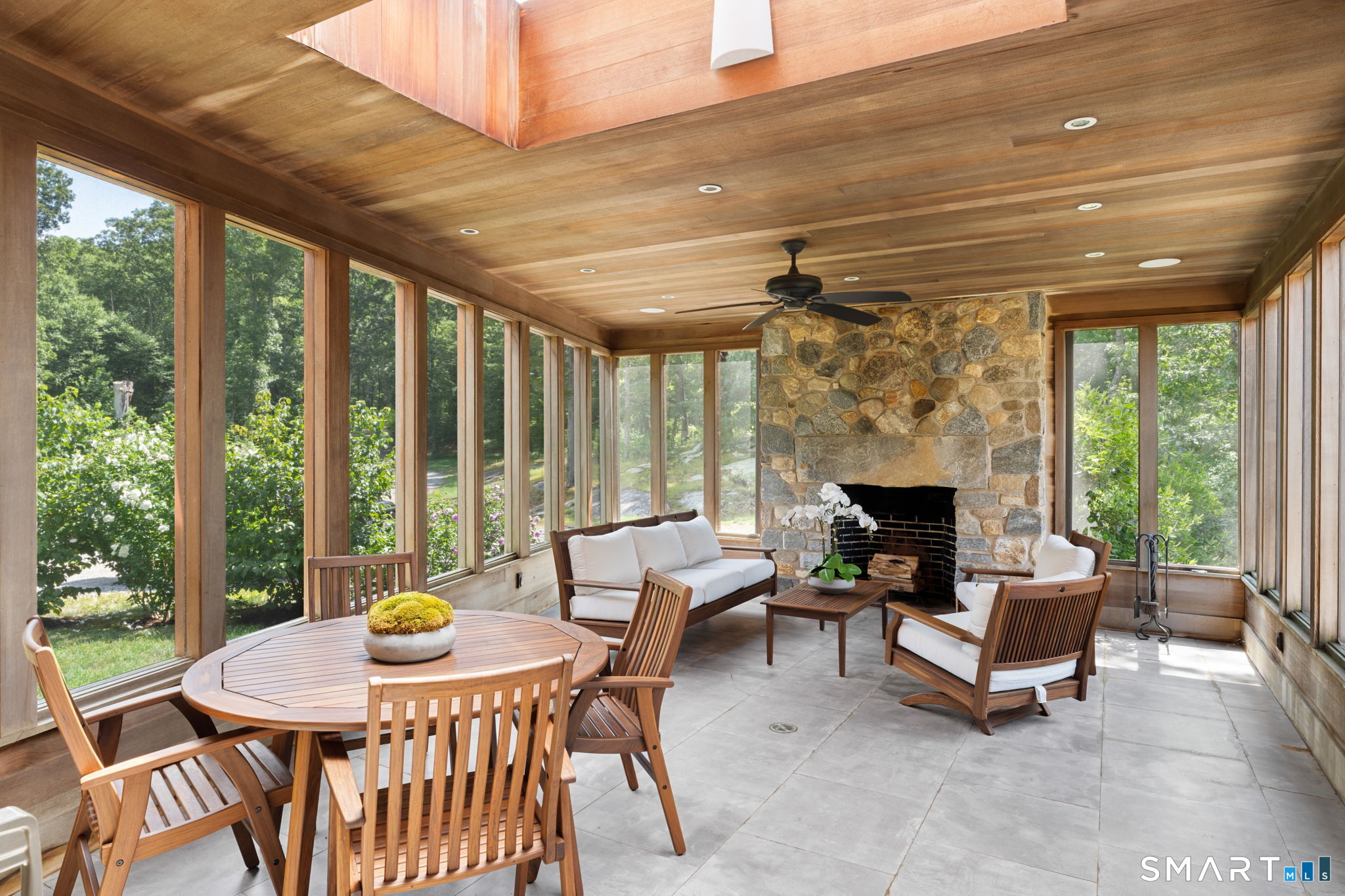 Screened in porch with stone fireplace