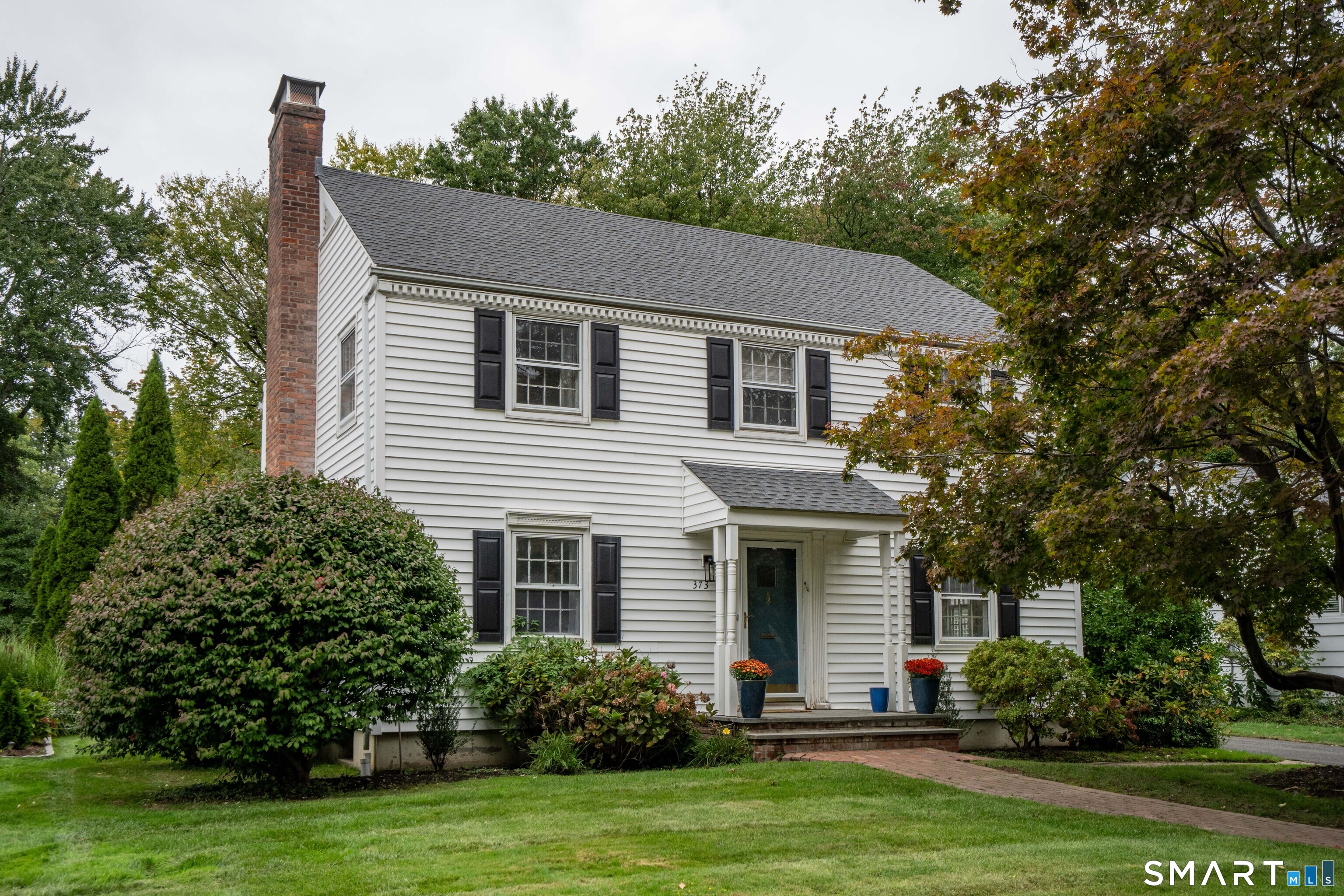 Delightful Colonial home with 4 bedrooms, 2.1 baths, and lovely updates! Step in from the tree-lined street, into the freshly renovated eat-in kitchen featuring white cabinetry and elegant white granite countertops. The kitchen opens to a spacious family room with a full wall of sliders allowing for maximum natural light, with views of the bluestone patio and level backyard creating an inviting connection to the outdoors. Just off the family room, a dedicated space provides an ideal home office or playroom. The front door opens into a gracious foyer flanked by a formal dining room and fireplaced living room and a pretty staircase. Upstairs, you will find a primary bedroom suite with a just renovated en-suite bath, along with three additional bedrooms - one with a cozy window seat - and a renovated hall bath. Full central air conditioning on the second floor. The finished basement offers additional living and recreation space, including a den with wood flooring, laundry room, space for a home gym, and ample storage. Gas heat and hot water and a two car garage add to the home's convenience. Ideally located near Morley, Elizabeth Park, Bishop's Corner shopping, and the vibrant shops and restaurants of West Hartford Center. Don't miss this classic Colonial offering generous spaces, thoughtful updates, and a sought after location.