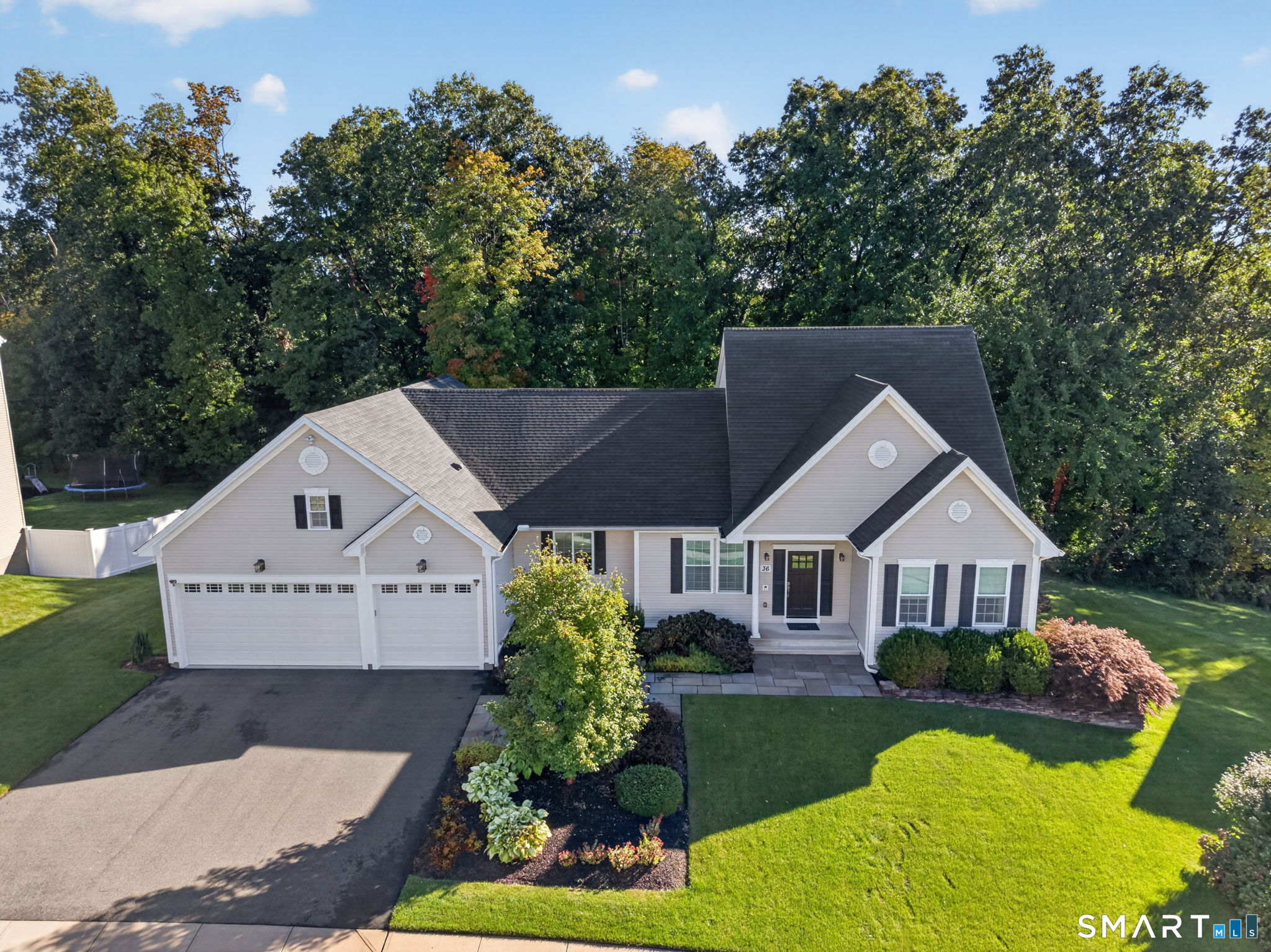Welcome to 36 West Poplar Road, a beautifully appointed custom home built in 2014 and ideally situated in the desirable Poplar Estates subdivision. Lightly lived in and meticulously maintained, this impressive home offers quality craftsmanship, generous living spaces, and the convenience of public utilities. A handsome bluestone walkway and welcoming front entrance set the tone as you arrive, while the three-car attached garage provides plenty of space for vehicles and storage. Step inside to gleaming hardwood floors and a freshly painted interior filled with natural light. All-new custom window blinds add a polished finishing touch throughout the home. The thoughtfully designed floor plan features a spacious first-floor primary suite, offering the ease and flexibility of main-level living while still providing ample additional space for family and guests. The custom design, beautiful finishes, and exceptional condition make this home truly move-in ready. Adding tremendous potential is the huge walkout lower level, offering an abundance of space ready to be finished for additional living areas, a recreation room, home gym, office, guest quarters, or whatever best suits your lifestyle. Set within an established neighborhood yet convenient to Middletown's shopping, dining, highways, and amenities, this exceptional property combines newer construction, custom details, public utilities, and room to grow-a wonderful opportunity in Poplar Estates.