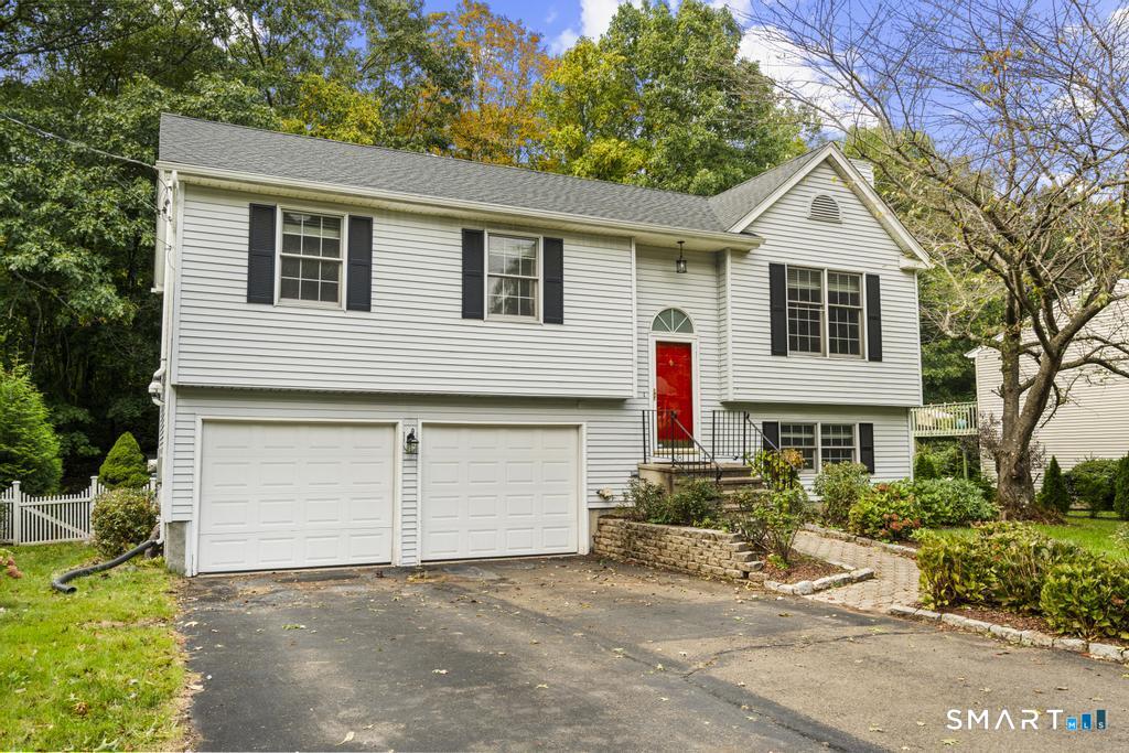 Well-maintained 3-bedroom, 3-full-bath raised ranch in Hamden's Mount Carmel neighborhood, offering a comfortable layout, finished lower level, and excellent outdoor space. The main floor features a spacious living room with fireplace, dining area with cathedral ceiling, and a bright kitchen with granite countertops, stainless-steel appliances, island, skylight, pantry, and generous cabinet space. The primary bedroom includes its own full bath, with two additional bedrooms and another full bath completing the main level.  The lower level expands the living space with a family room, full bath, laundry area, and walk-out access. Outside, enjoy multiple decks and an enclosed yard with room for relaxing or entertaining. A 2-car garage, central air, zoned heating, replacement windows, updated mechanicals, and private driveway add everyday convenience. Located on a quiet cul-de-sac, this well-cared-for home offers space, flexibility, and privacy in a convenient Hamden setting.