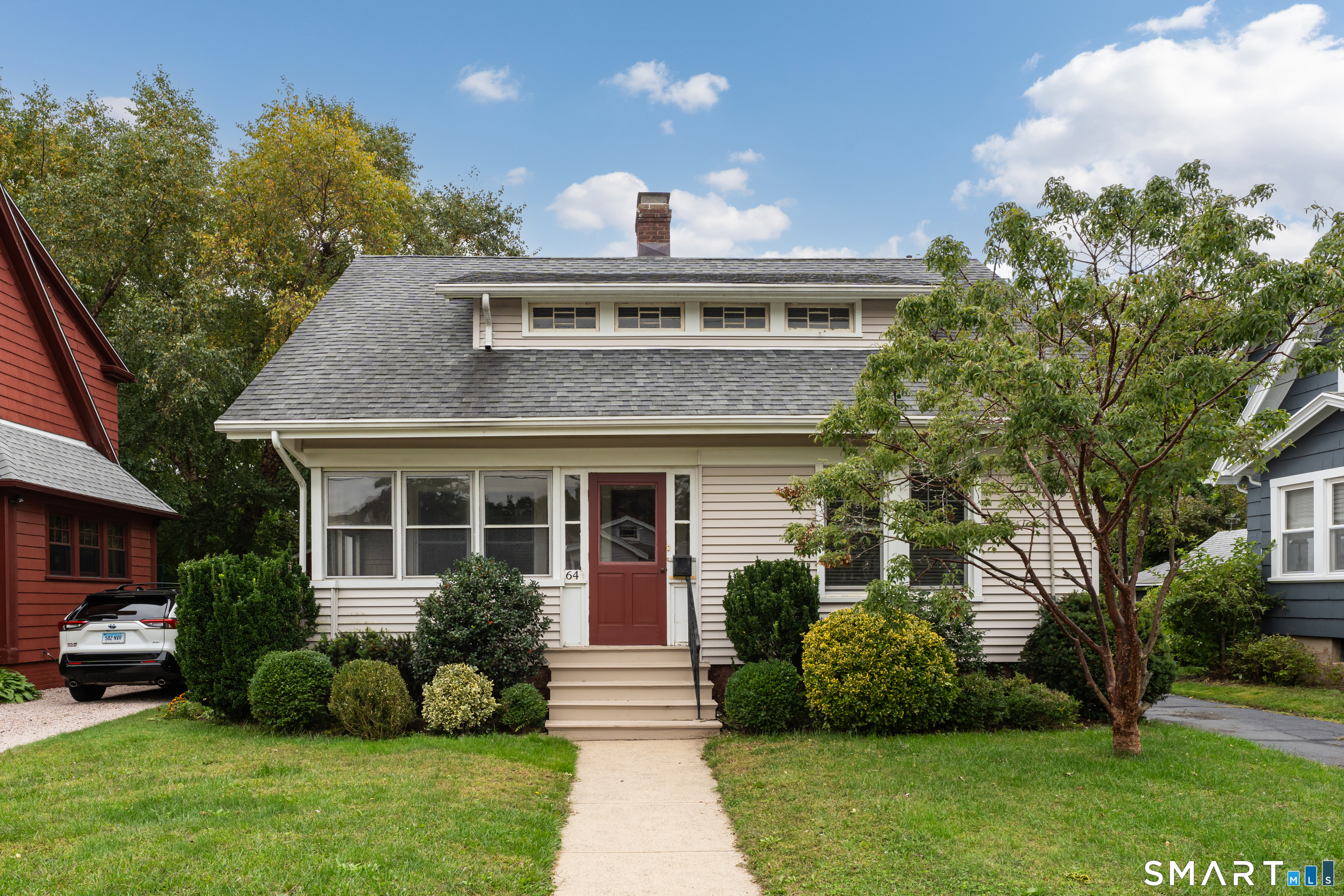Built in 1914, this craftsman-style Cape sits on a quiet, peaceful street and still has the character that makes homes of this era special. Box-beam ceilings in the living room, dining room, and family room set the tone, and hardwood floors run throughout. The modern kitchen has loads of cabinets with a center island including additional cabinetry, stainless appliances including a nearly new refrigerator and a six-burner gas range with a center griddle, granite counters and recessed lighting, all to delight the cook in the family! A mudroom off the kitchen opens to a large back deck overlooking an enchanting backyard, the perfect spot for morning coffee, al fresco dining, and quiet evenings. An enclosed front porch/breezeway adds a welcoming entry and extra living space for three seasons. There's an updated half bath on the main floor, and the updated full bath upstairs includes a large, partially finished bonus room/closet with plenty of potential. There are 2 large bedrooms on the second floor and a third smaller room ideally used as a nursery, office space, or storage room. A two-car garage, a 2016 roof, and vinyl siding round out a home with good bones, ready for its next owners to add their own finishing touches.