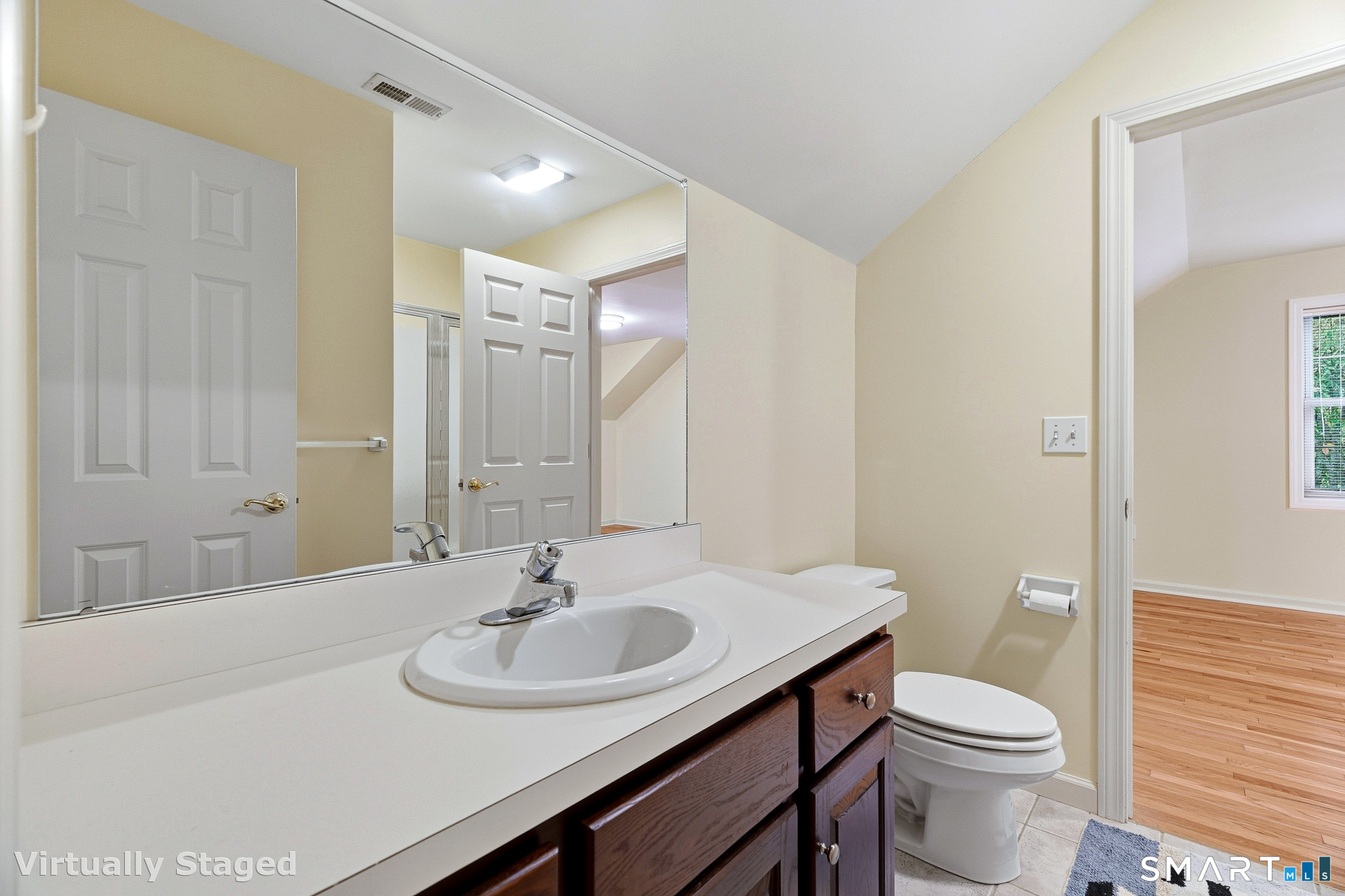 Second floor full bath opens to the bedroom and the den area